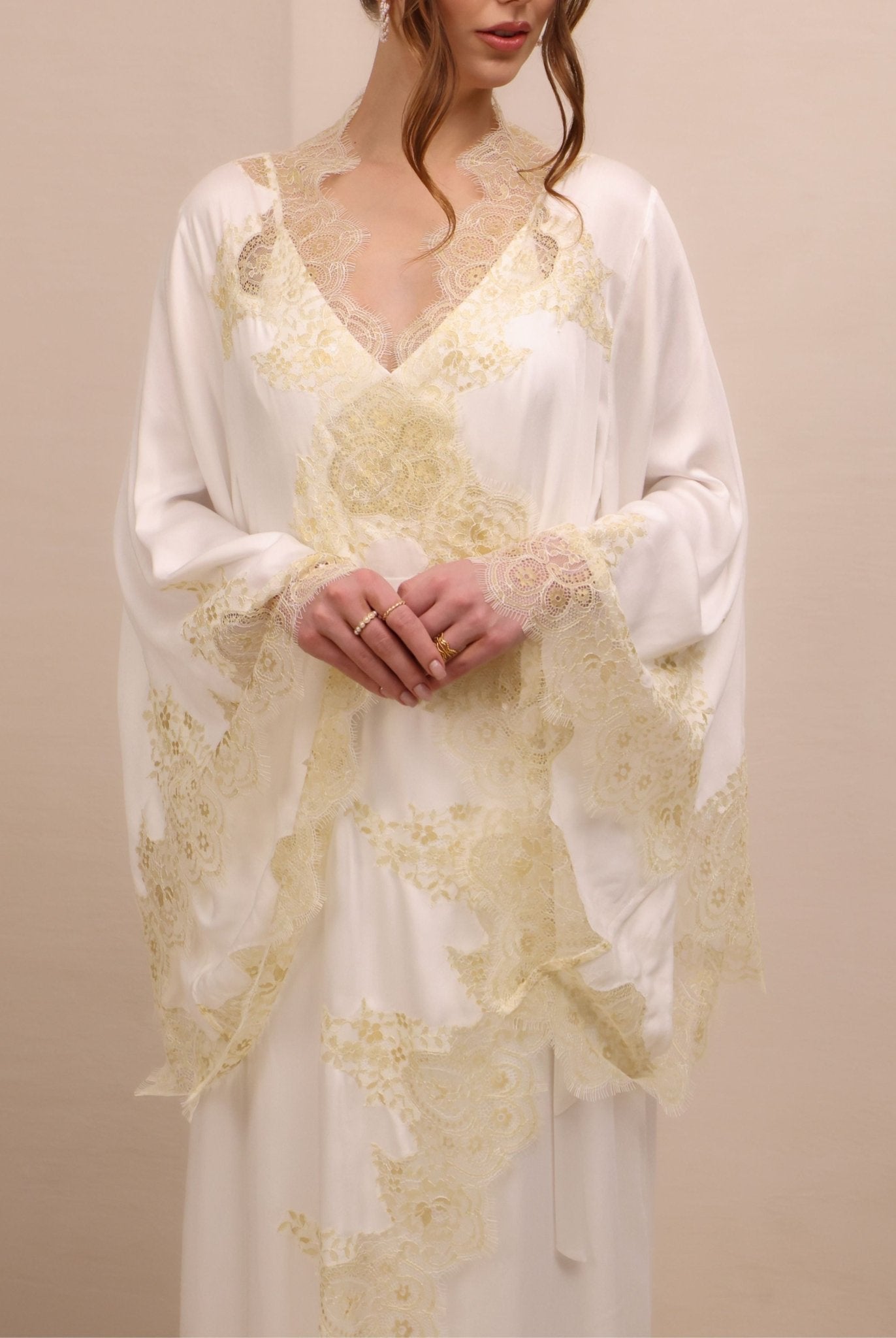 A mid-length shot focusing on the wide sleeves and the asymmetric lace placement that adds presence to the look.