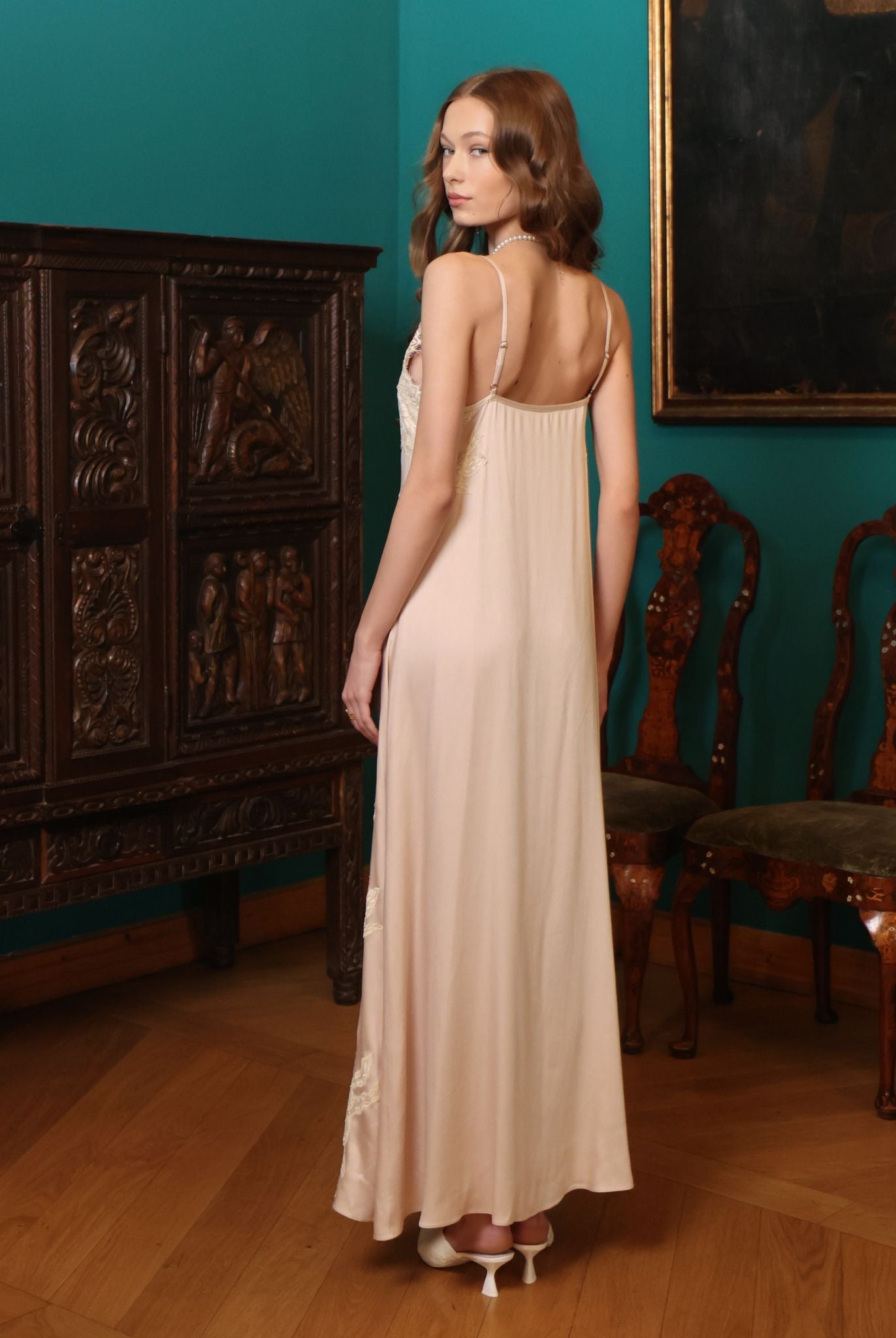 Rear view of the nightgown, highlighting the smooth drape and the subtle feminine charm of the lace-trimmed hem.