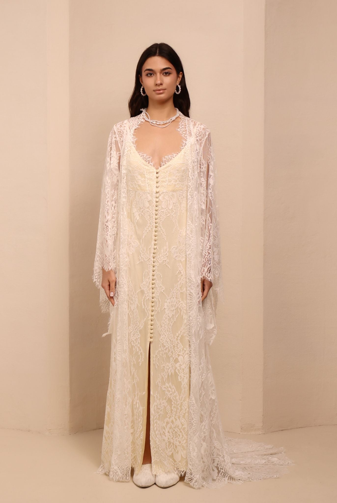 A serene static shot of the ensemble, showcasing the delicate sheer lace robe draping beautifully over the body.