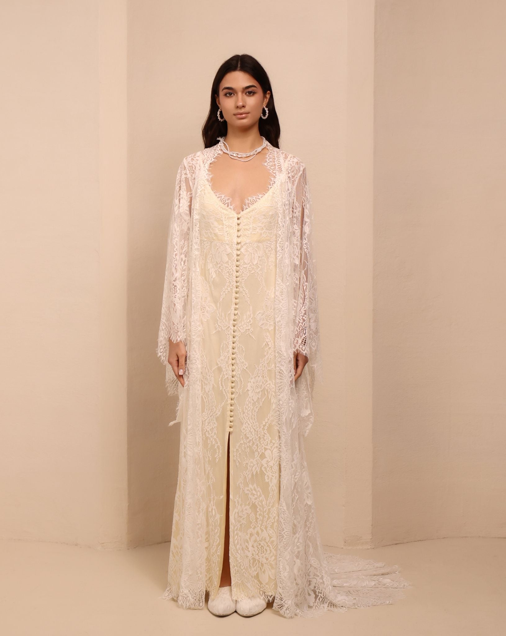 A serene static shot of the ensemble, showcasing the delicate sheer lace robe draping beautifully over the body.
