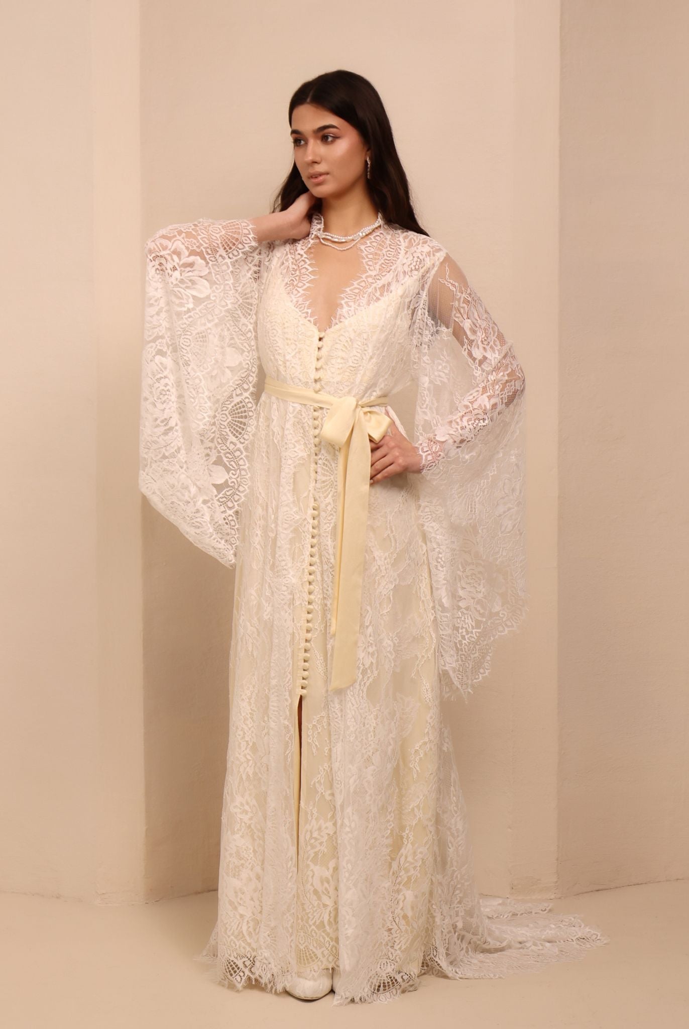 A side perspective of the attire, highlighting the graceful silhouette and the soft flow of the fabric.