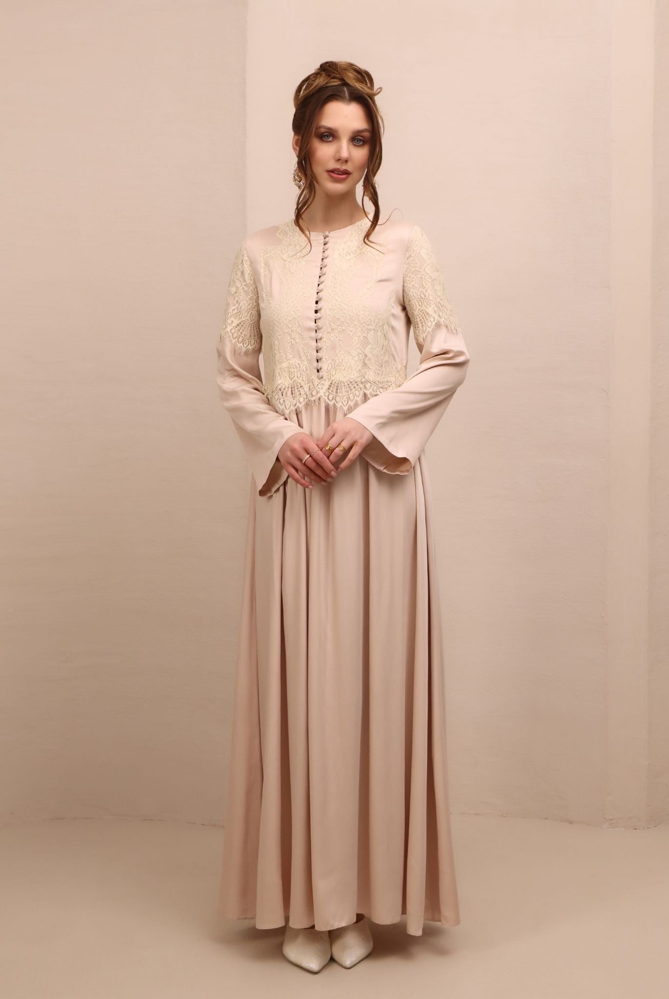 Frontal view of the nightgown, featuring a high neckline, long sleeves, and small buttons covered in fabric.
