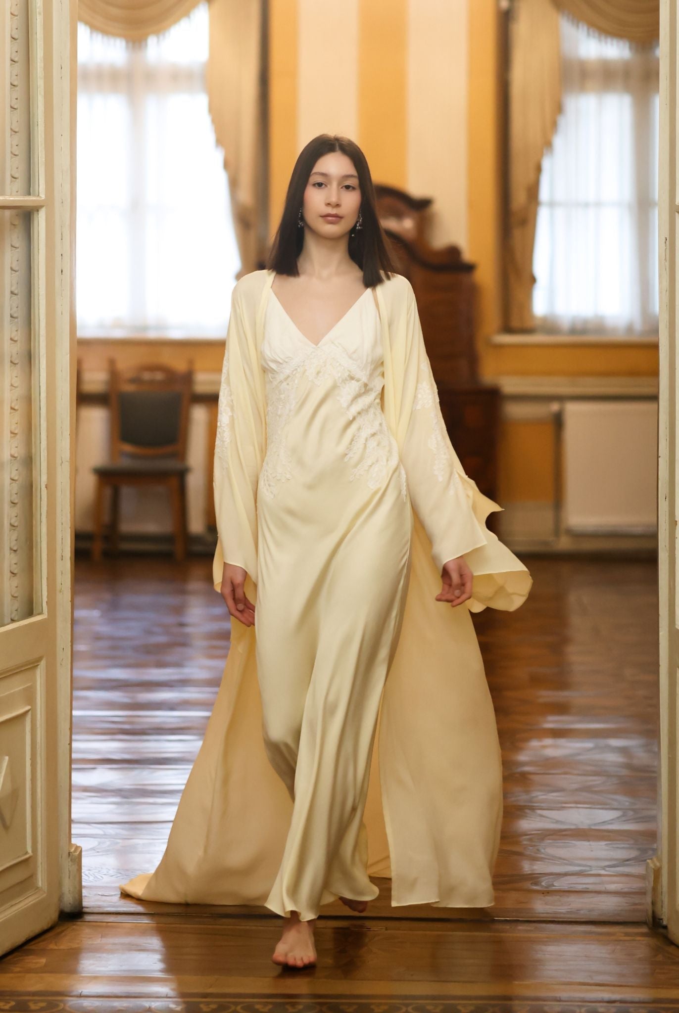 A dynamic view of the sheer chiffon robe in motion, highlighting the slit sleeves and sophisticated drama.