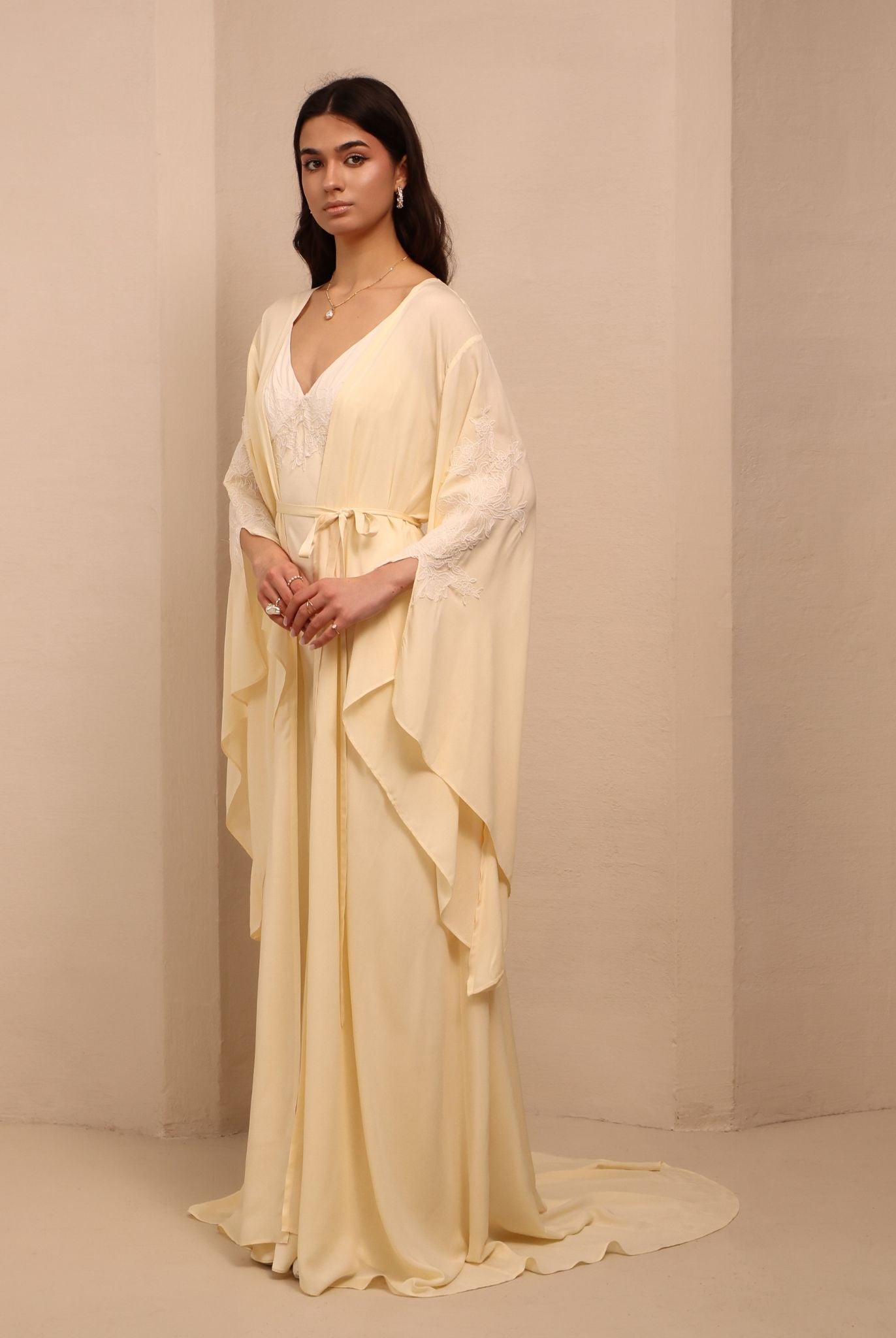 Side perspective of the tied ensemble, showcasing the sleeve slits and the sophisticated drama of the design.