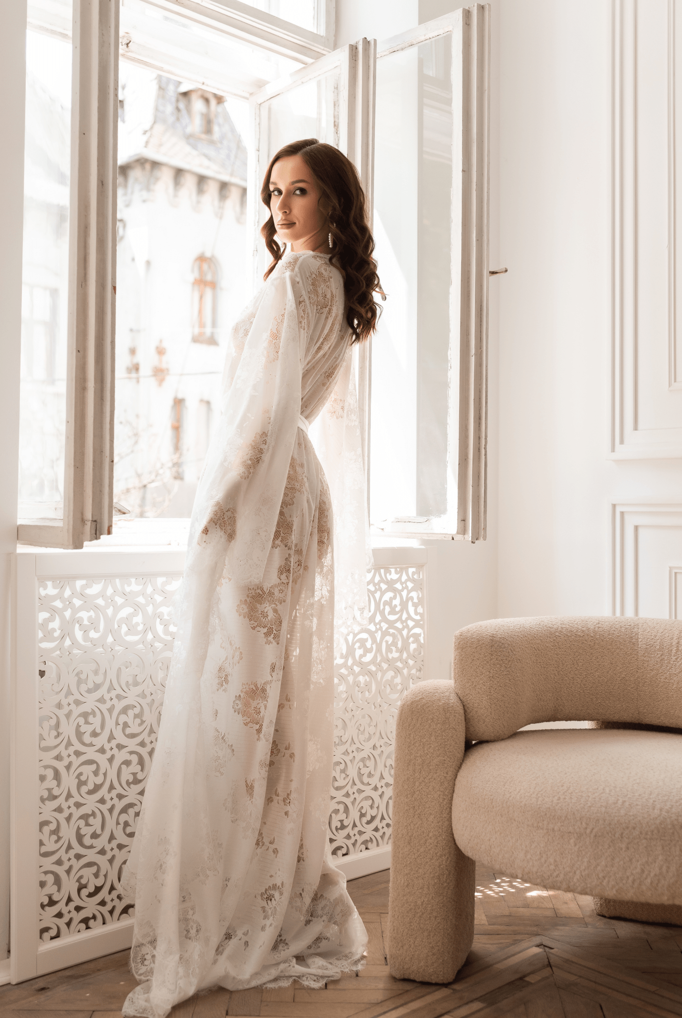 Side view of woman in white lace robe gazing out the window – KÂfemme