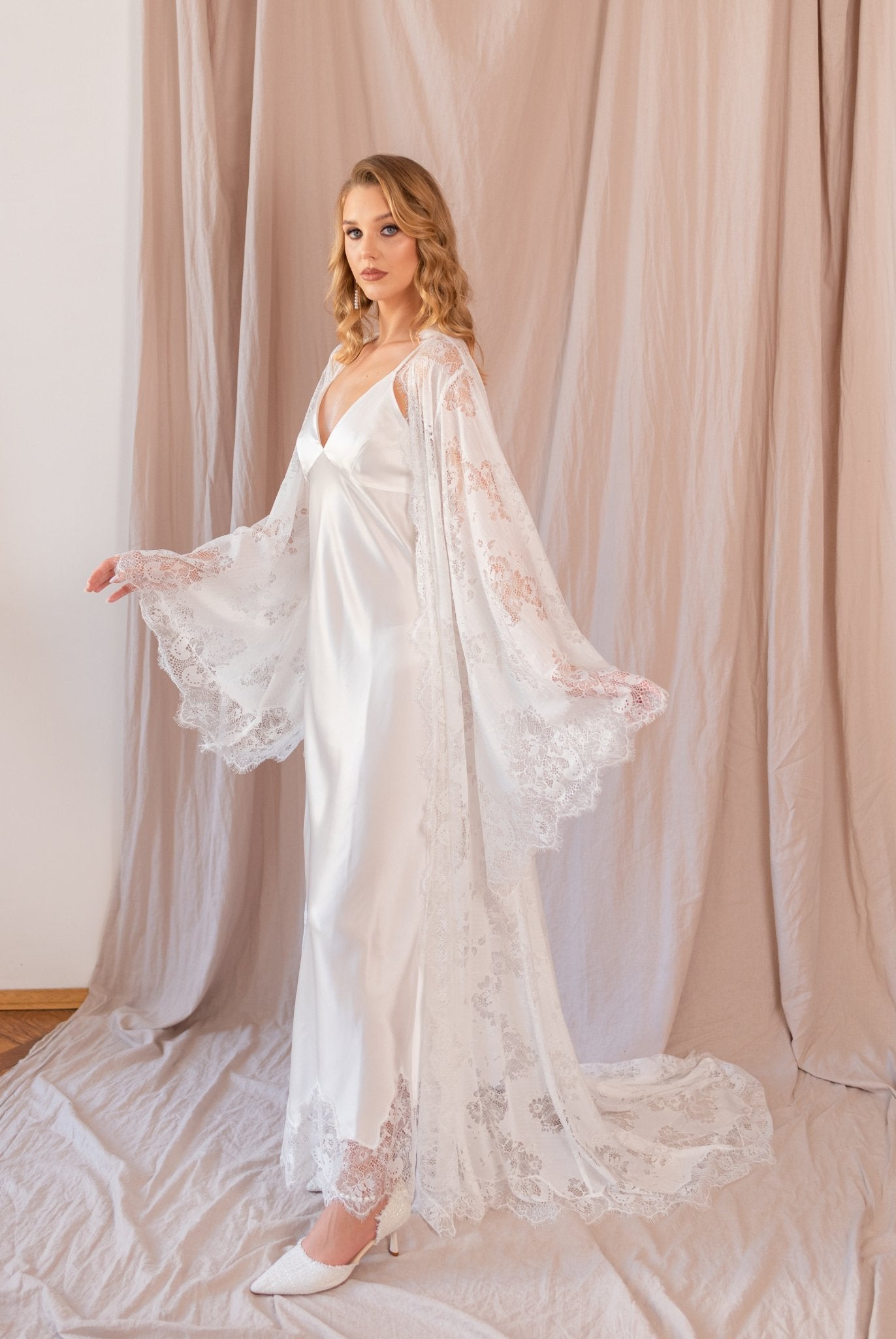 Woman wearing sheer white lace robe and nightgown set