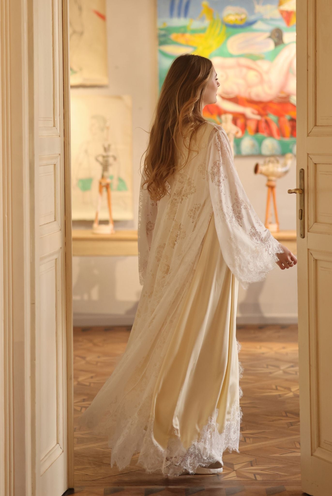 A full-height shot from behind, illustrating how the lace-trimmed layers move beautifully with the body's rhythm.