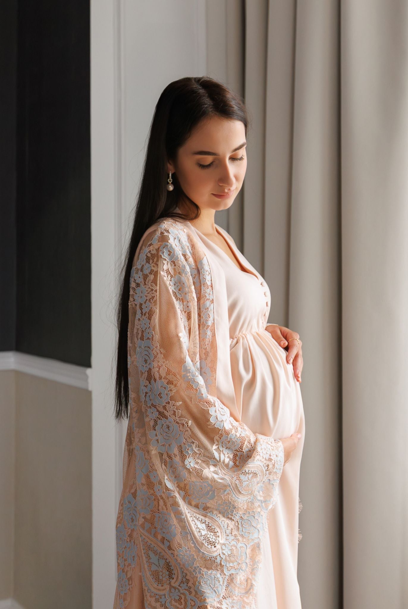 Side profile mid-length view showcasing the delicate lace detailing and the comfortable fit over a growing bump.