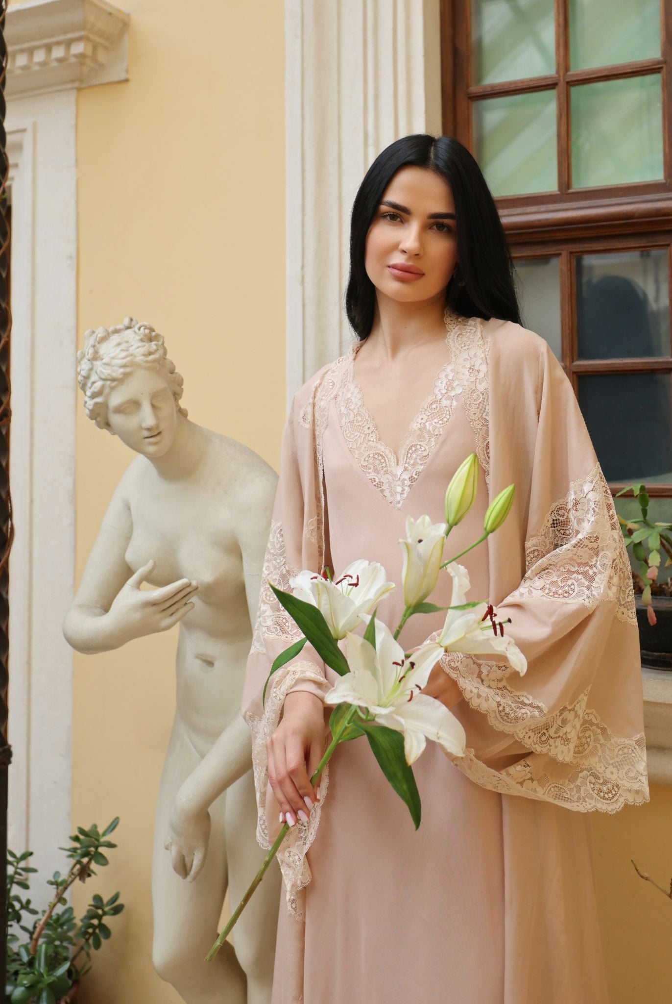 A creative artistic shot featuring a lily, emphasizing the natural ease and exquisite femininity of the collection.