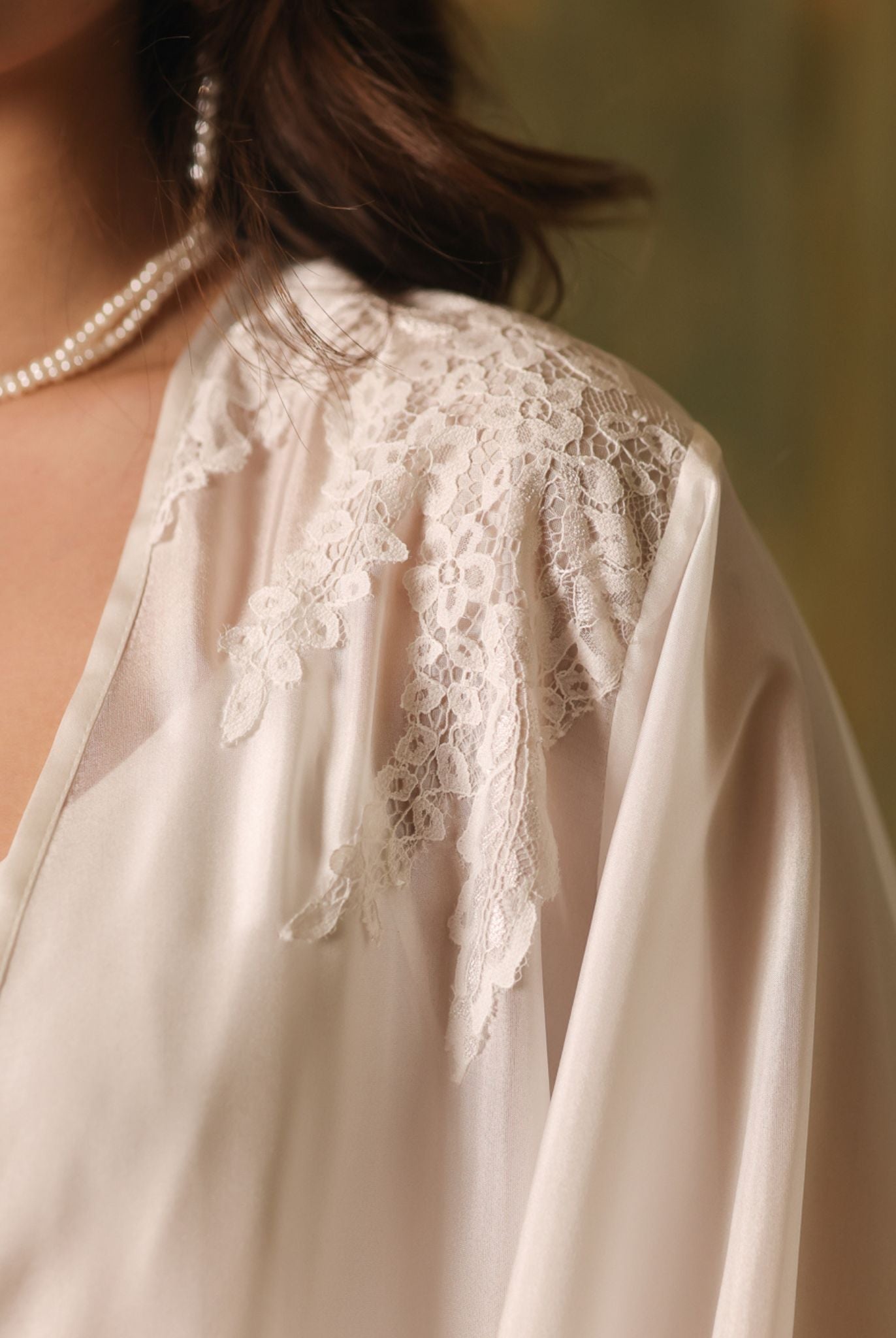 Close-up of the robe's shoulder, showcasing the intricate lace accents and the airy texture of mulberry silk.
