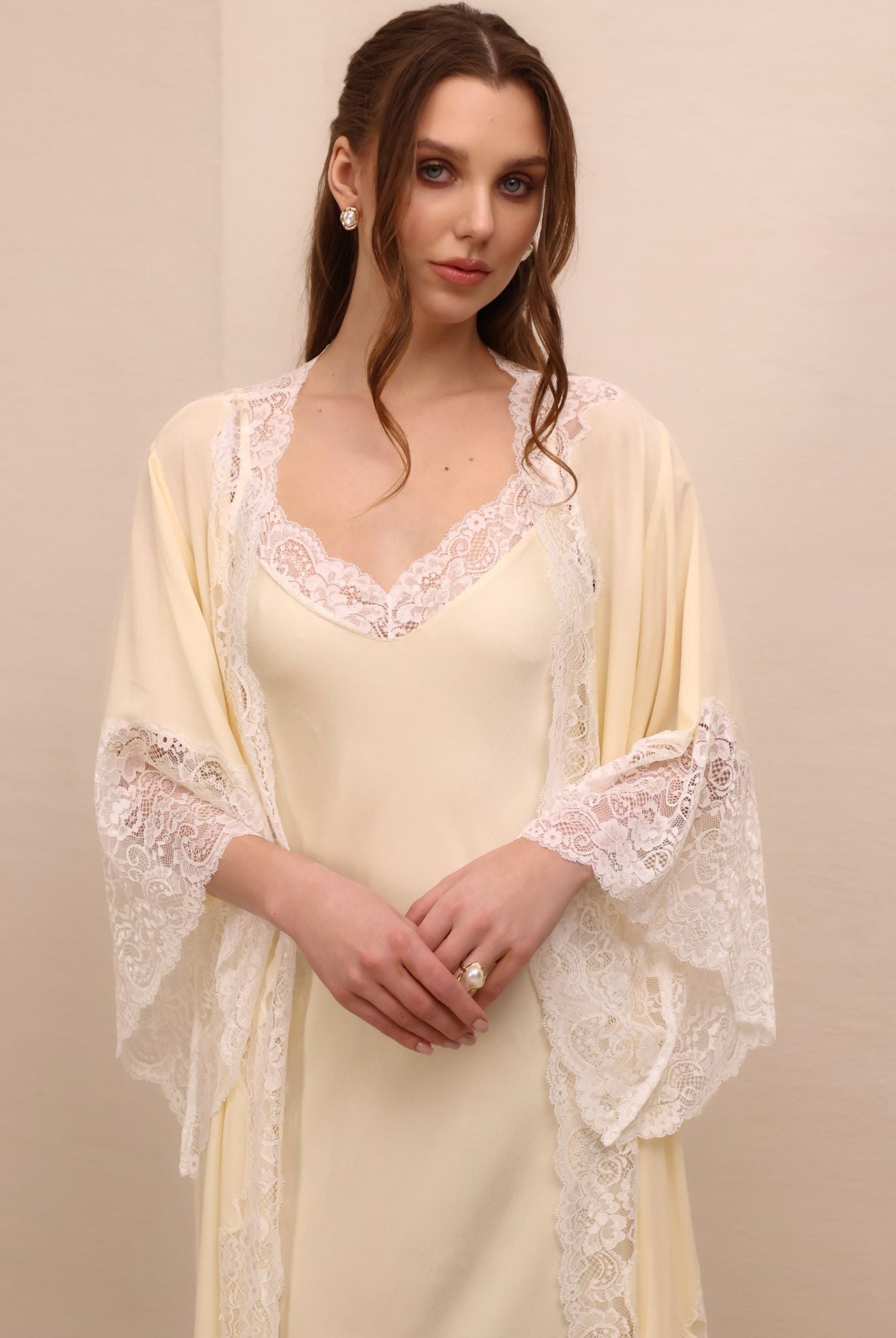 A mid-length shot highlighting the detailed lace sleeves and the graceful neckline for unforgettable moments at home.