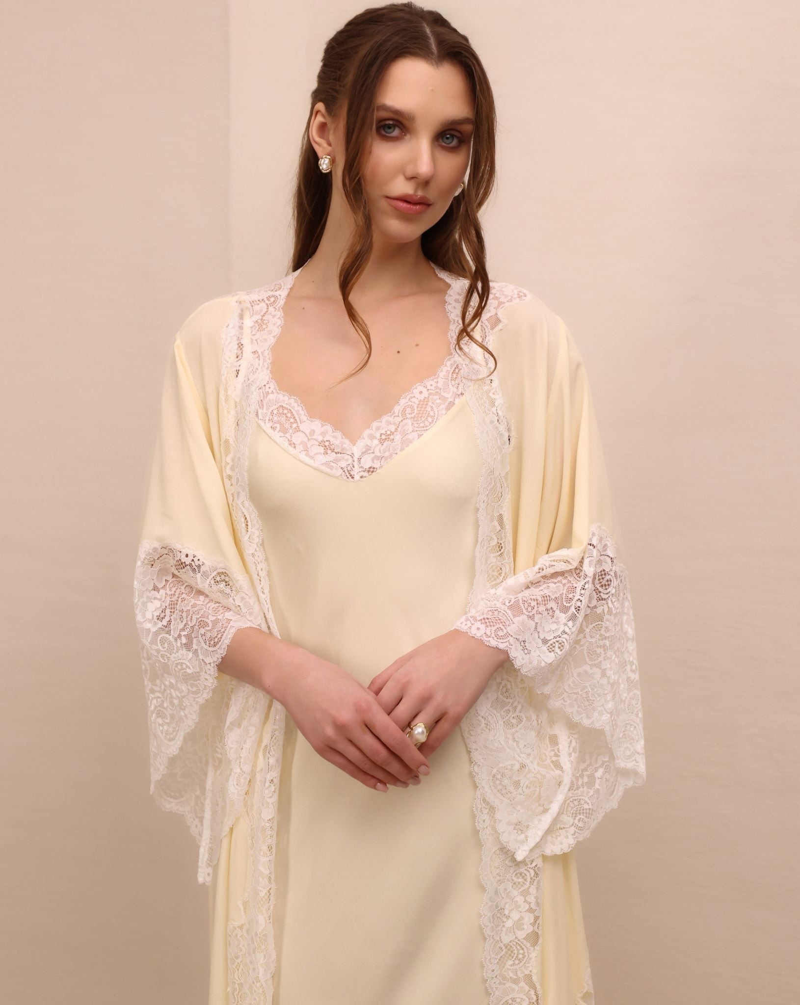 A mid-length shot highlighting the detailed lace sleeves and the graceful neckline for unforgettable moments at home.