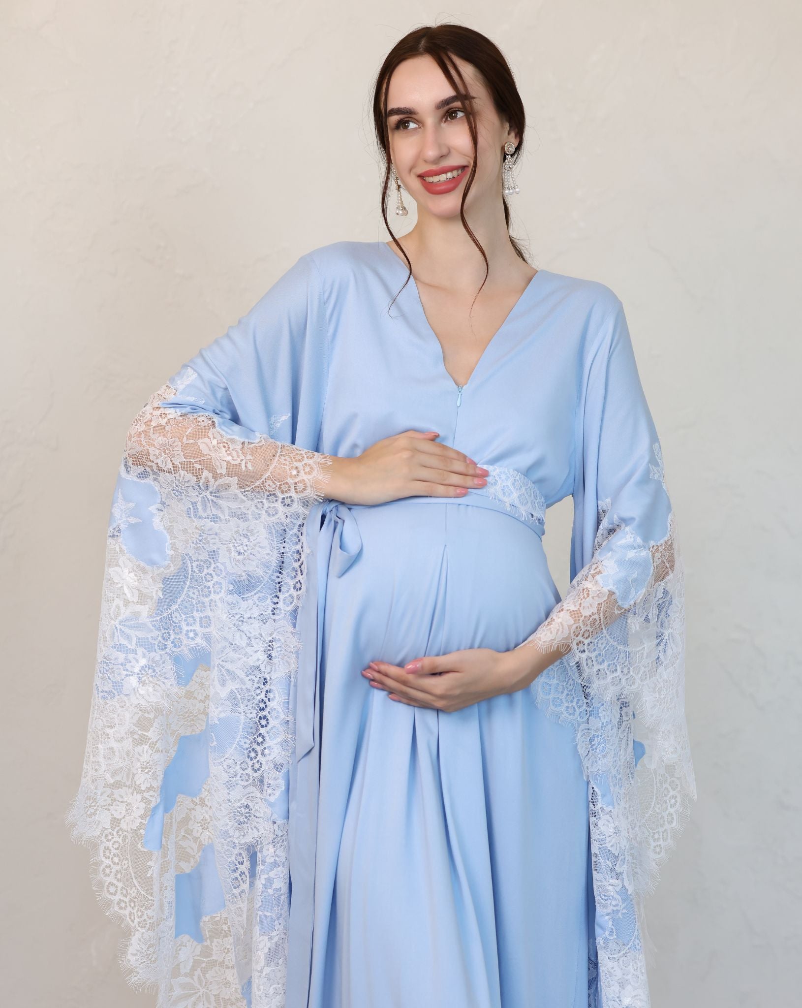 Mid-length frontal view with hands cradling the bump, highlighting the comfortable fit and hidden nursing zipper.