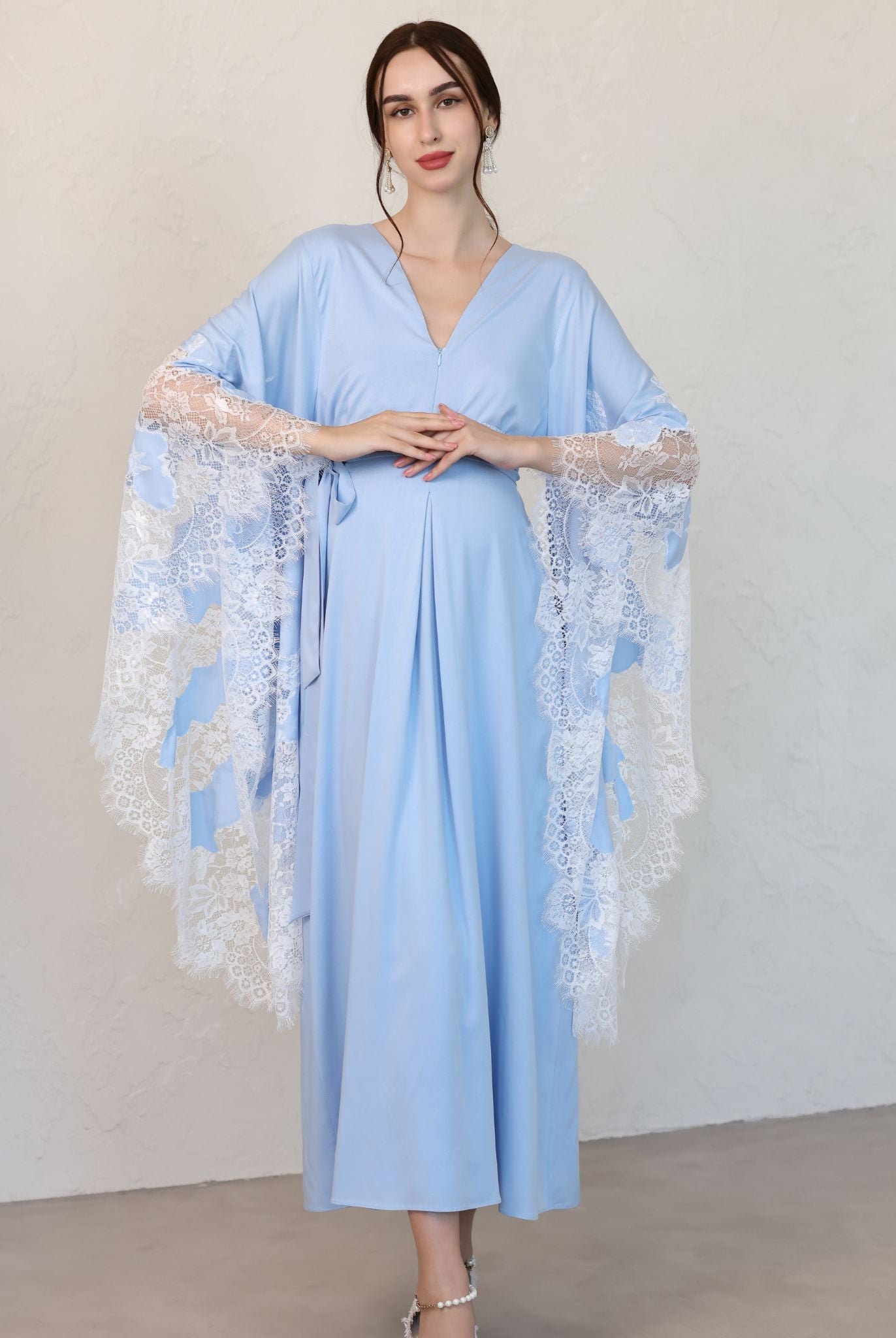 A full-length Maternity Kaftan with hands on the belly, showcasing the loose silhouette and lace-finished sleeves.