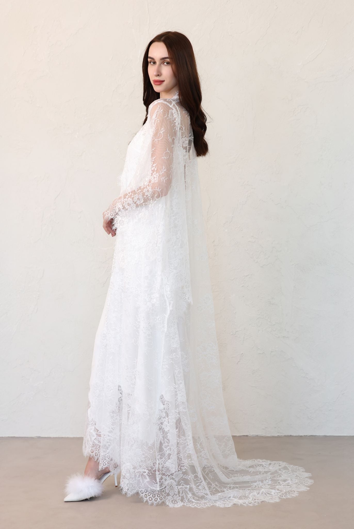 Bride facing left, train of robe displayed across floor