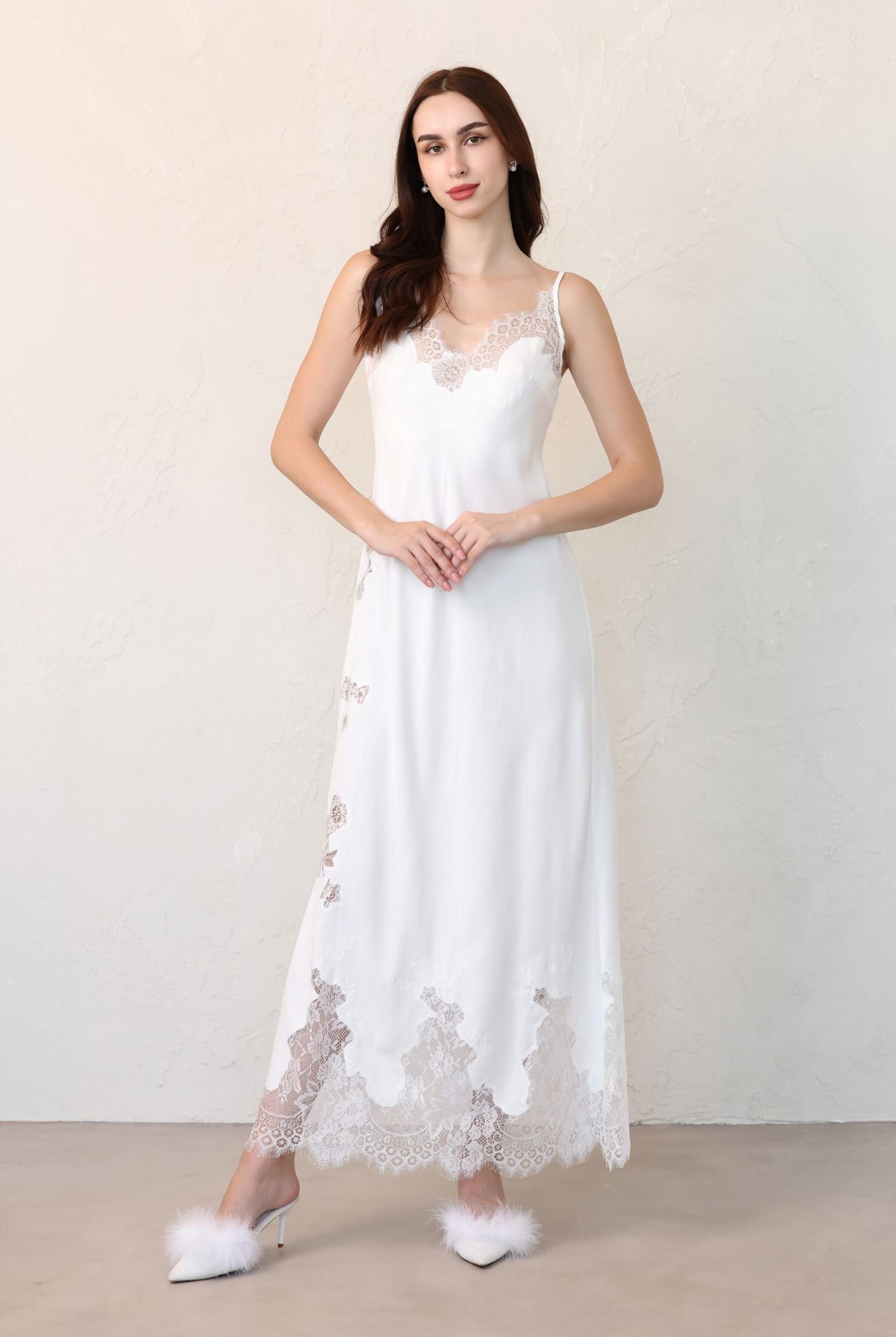 Bride standing with hands on waist, showcasing bridal set