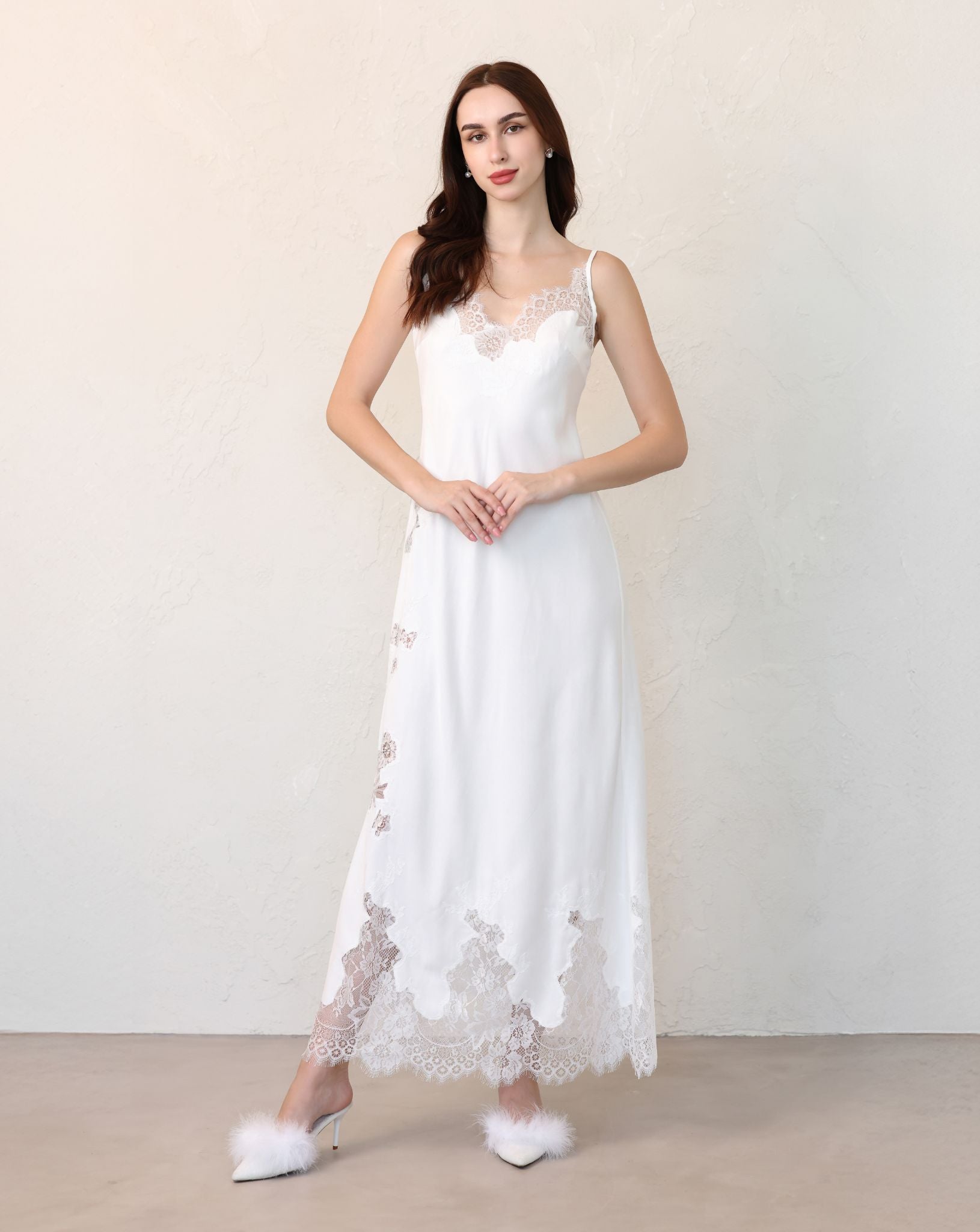 Bride standing with hands on waist, showcasing bridal set