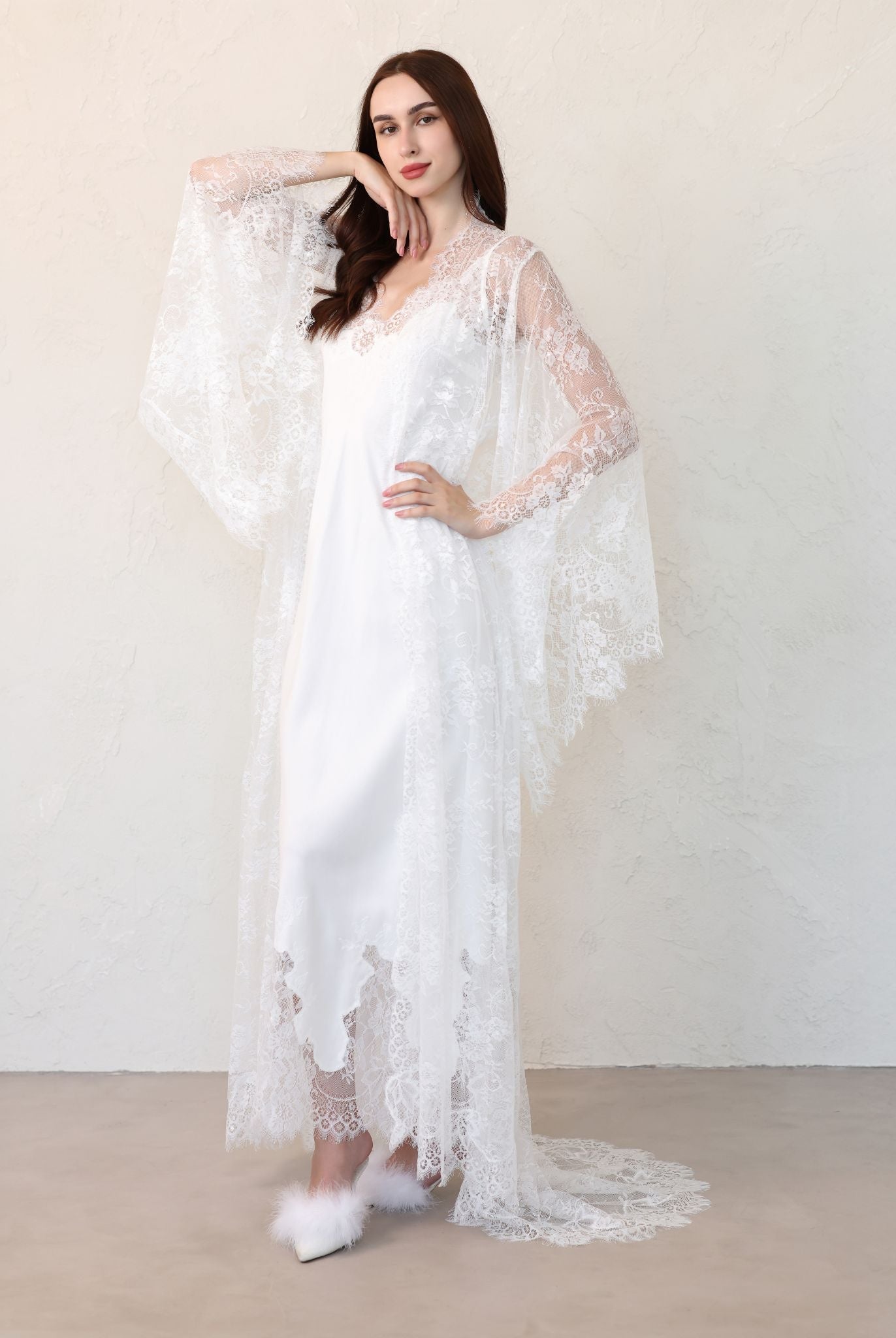 Bride adjusting lace robe sash, side view
