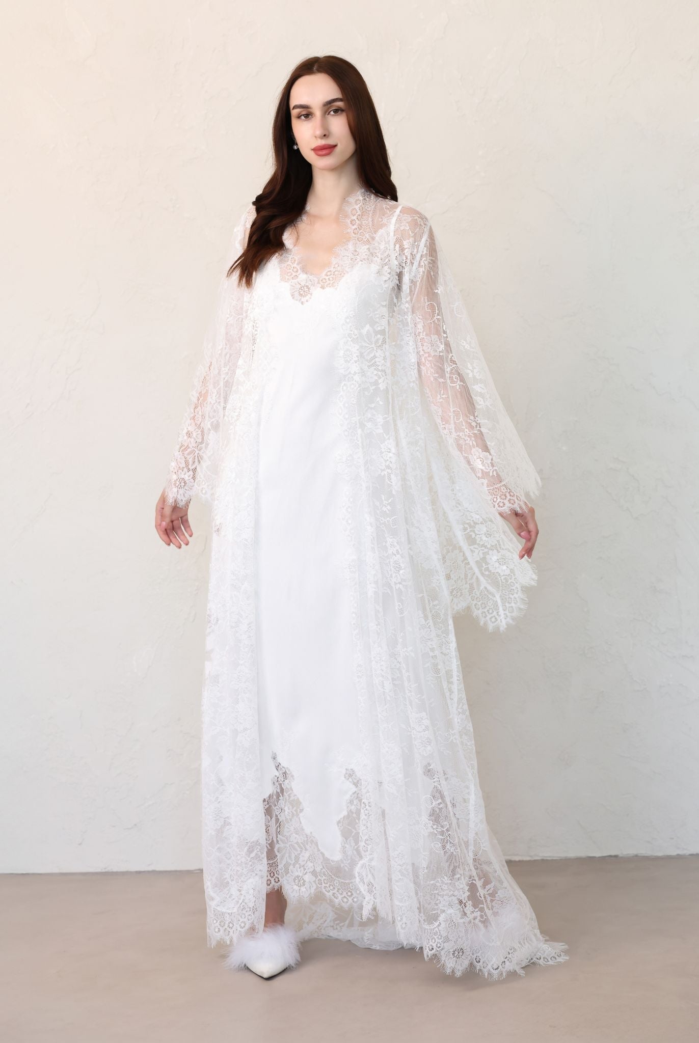 Bride walking forward in full-length lace robe over cotton dress