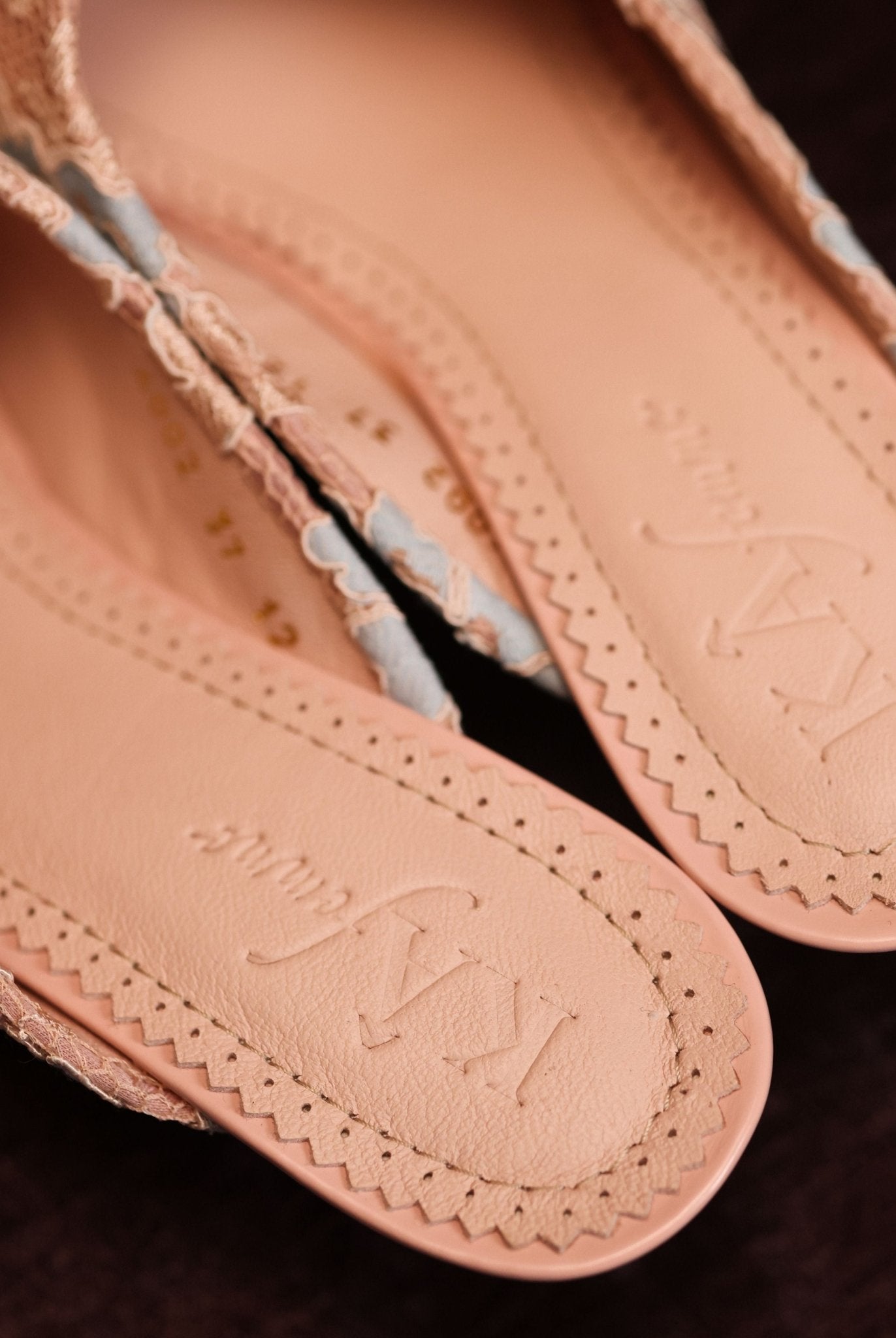 Top view of the footwear without feet, showcasing the brand logo on the leather insole and the classic silhouette.