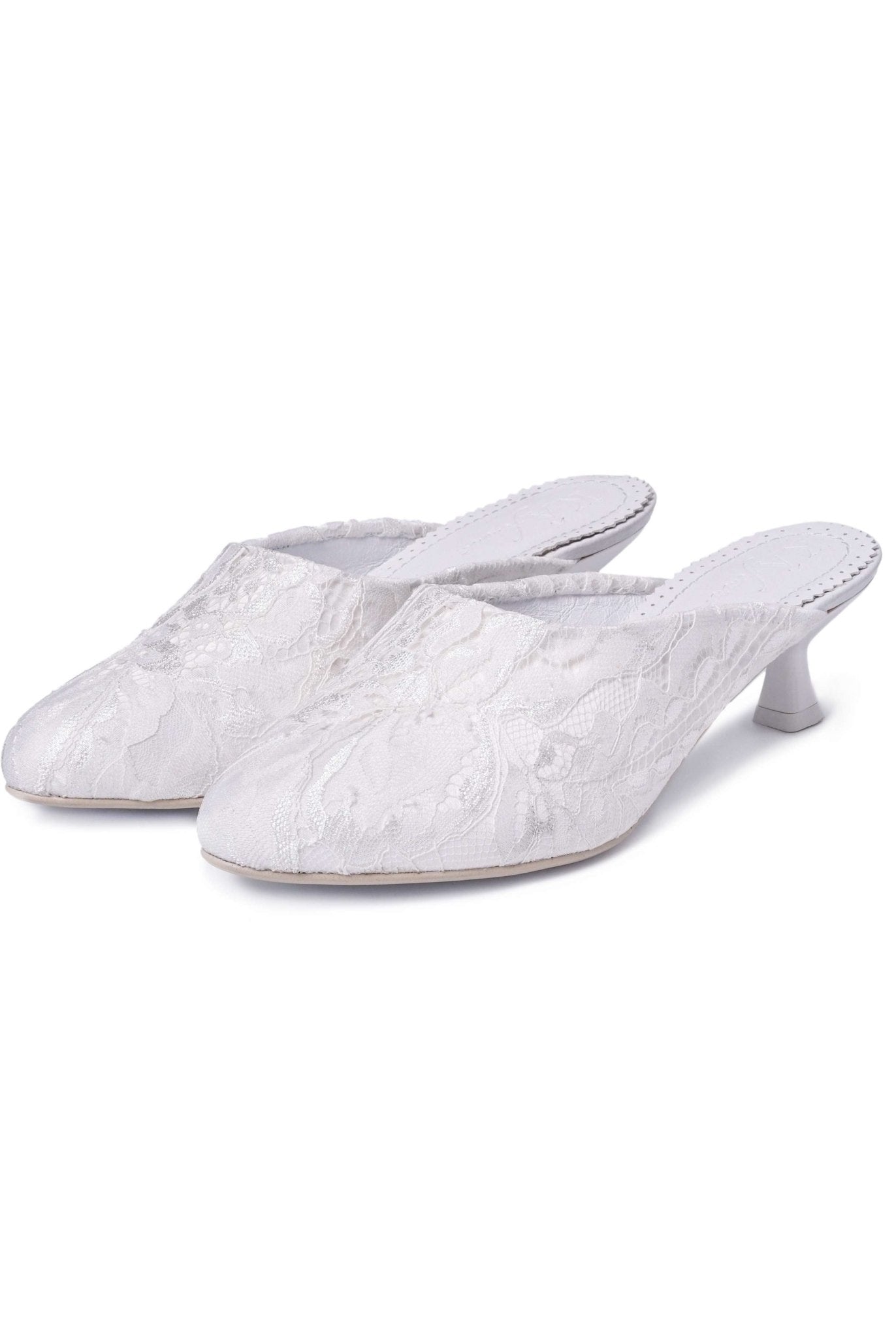 A snapshot of two heeled slippers standing positioned next to each other on a seamless white surface.