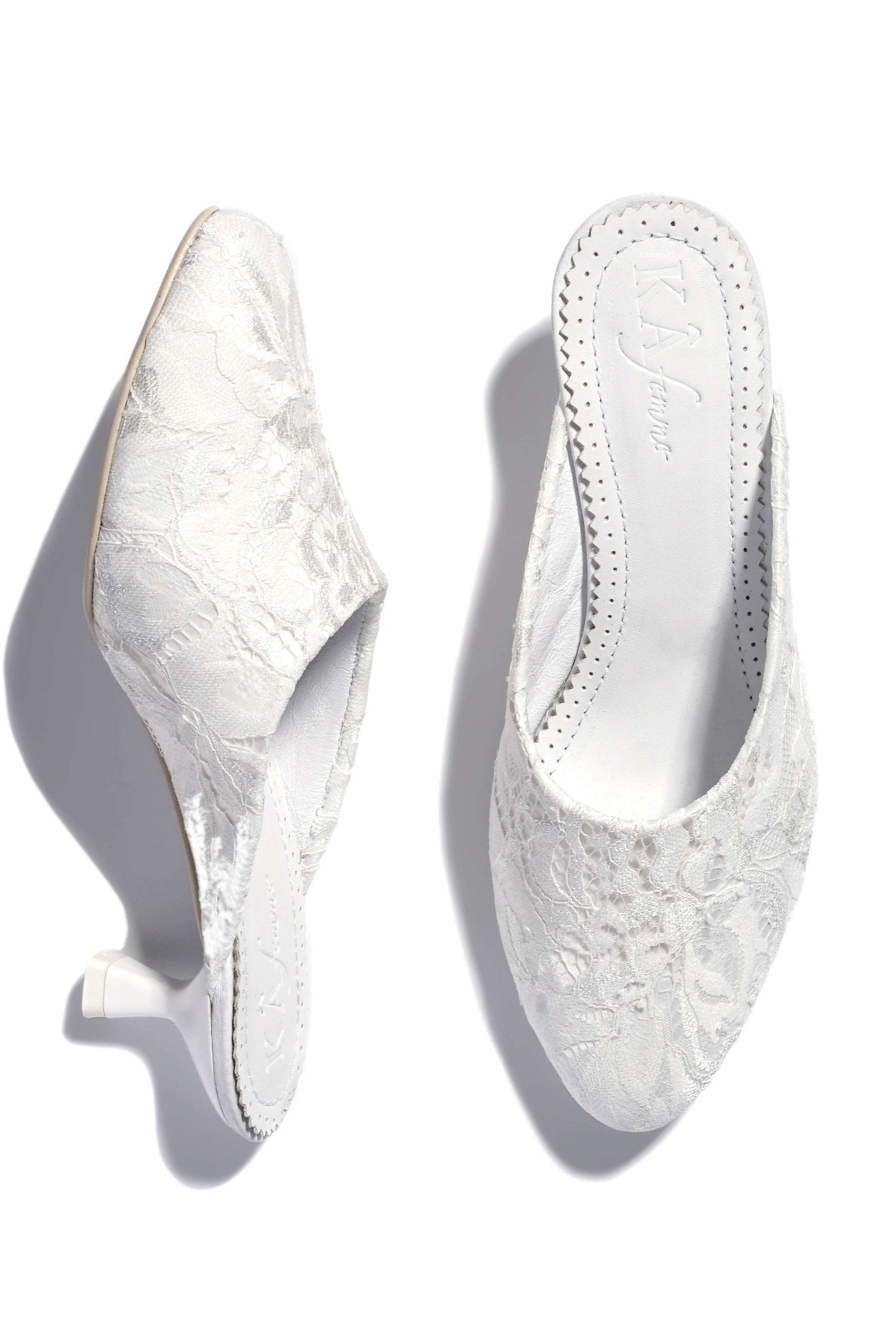 A detailed view of the slippers on a white background, displaying one shoe standing upright and the other placed flat.