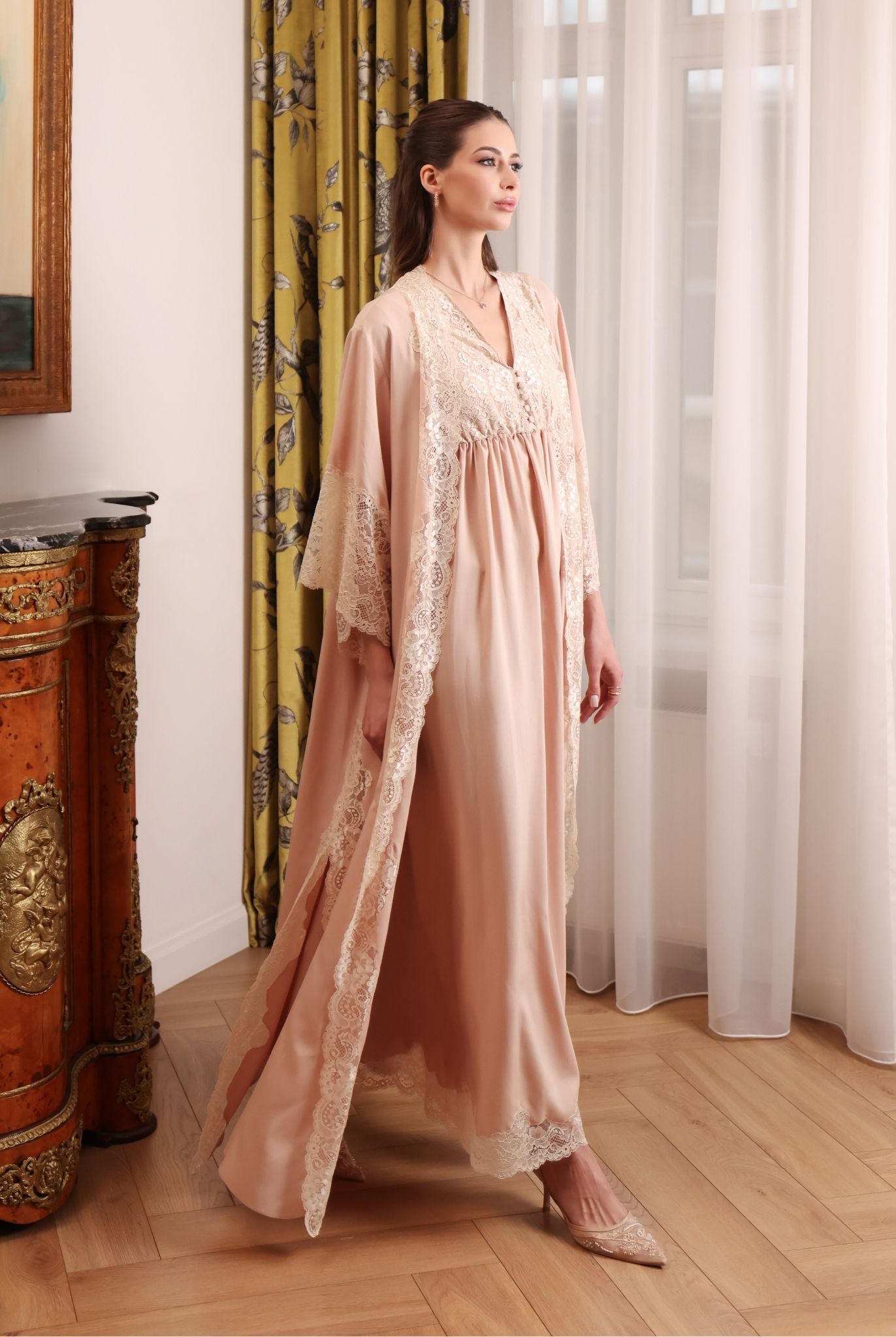 A side-view motion shot of the long robe, wrapping the body in softness that breathes and flows effortlessly.