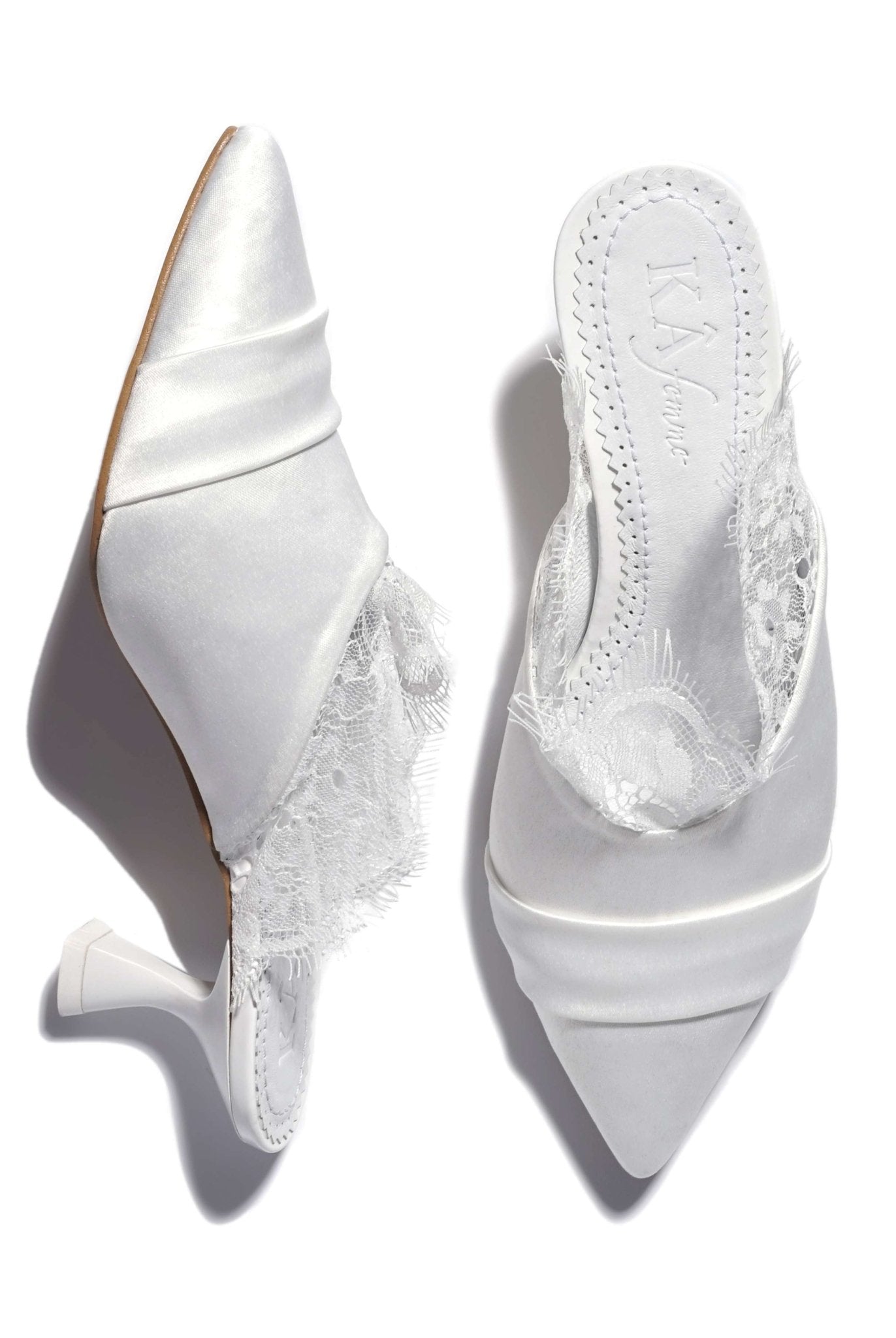 A shot of the slippers on a white background, where one shoe stands and the other lies to show the heel.