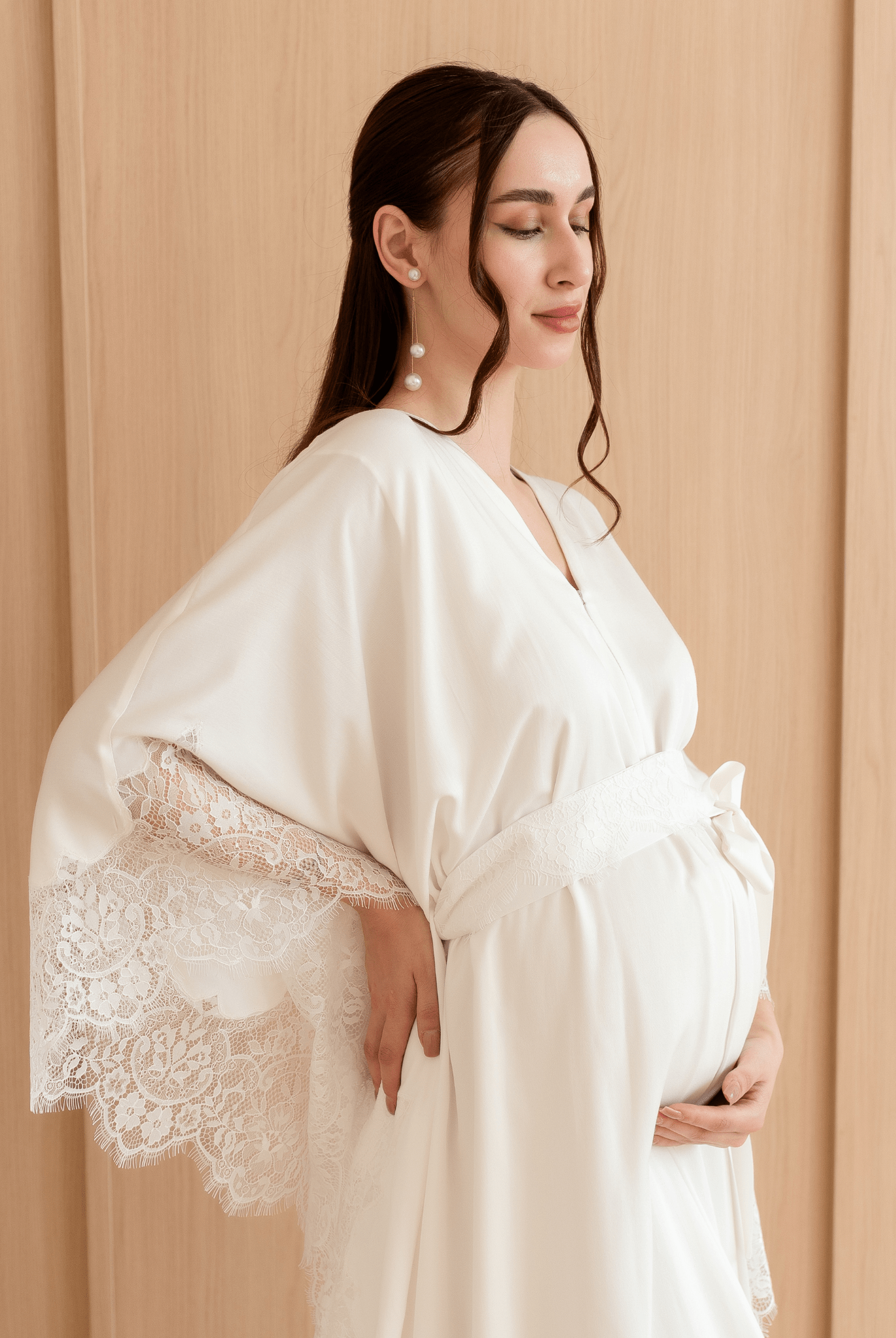 A side view of the maternity ensemble, emphasizing the natural drape and the discreet front zipper for nursing.