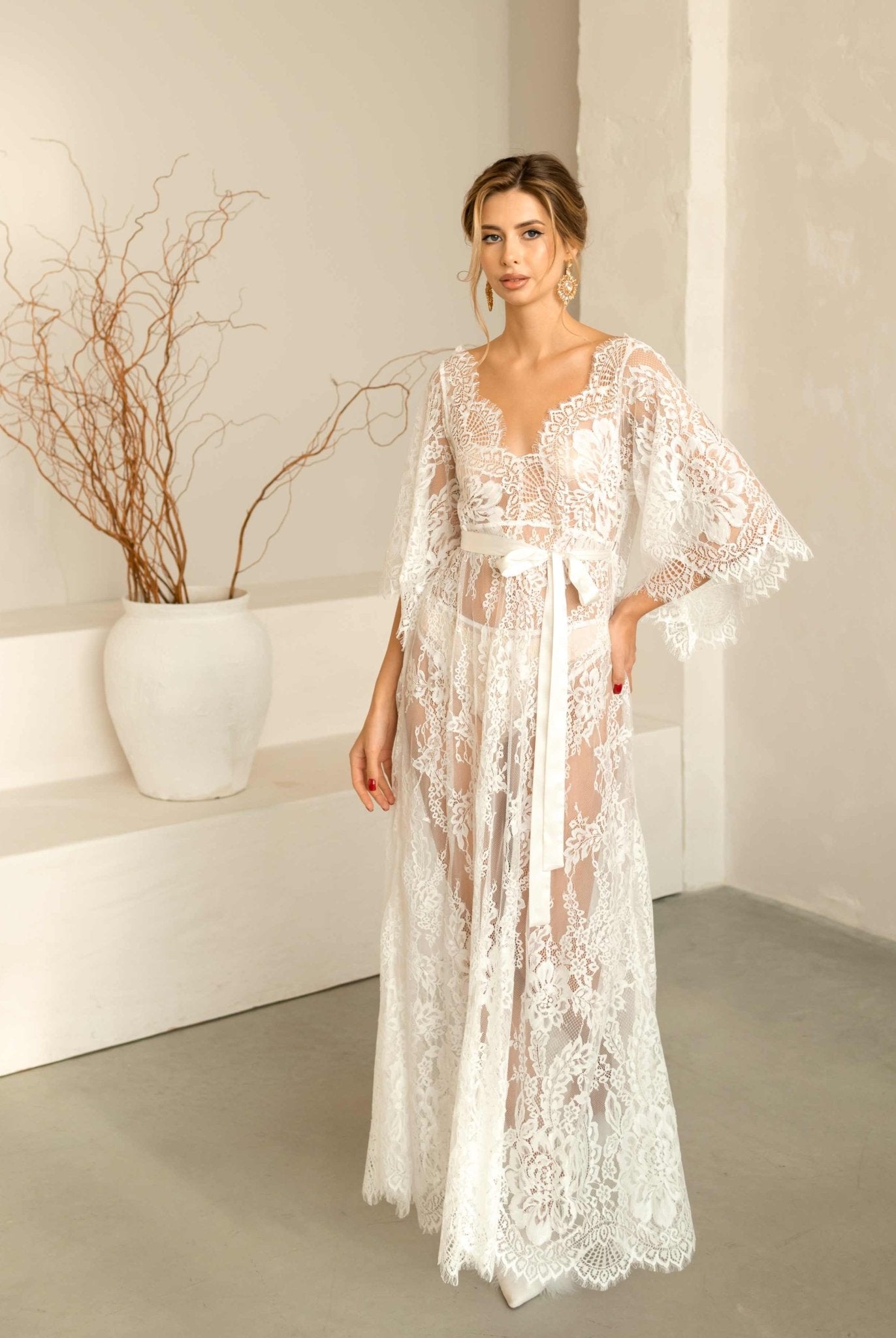 Beautiful model standing in the elegant Wedding Nightgown made of delicate white lace.