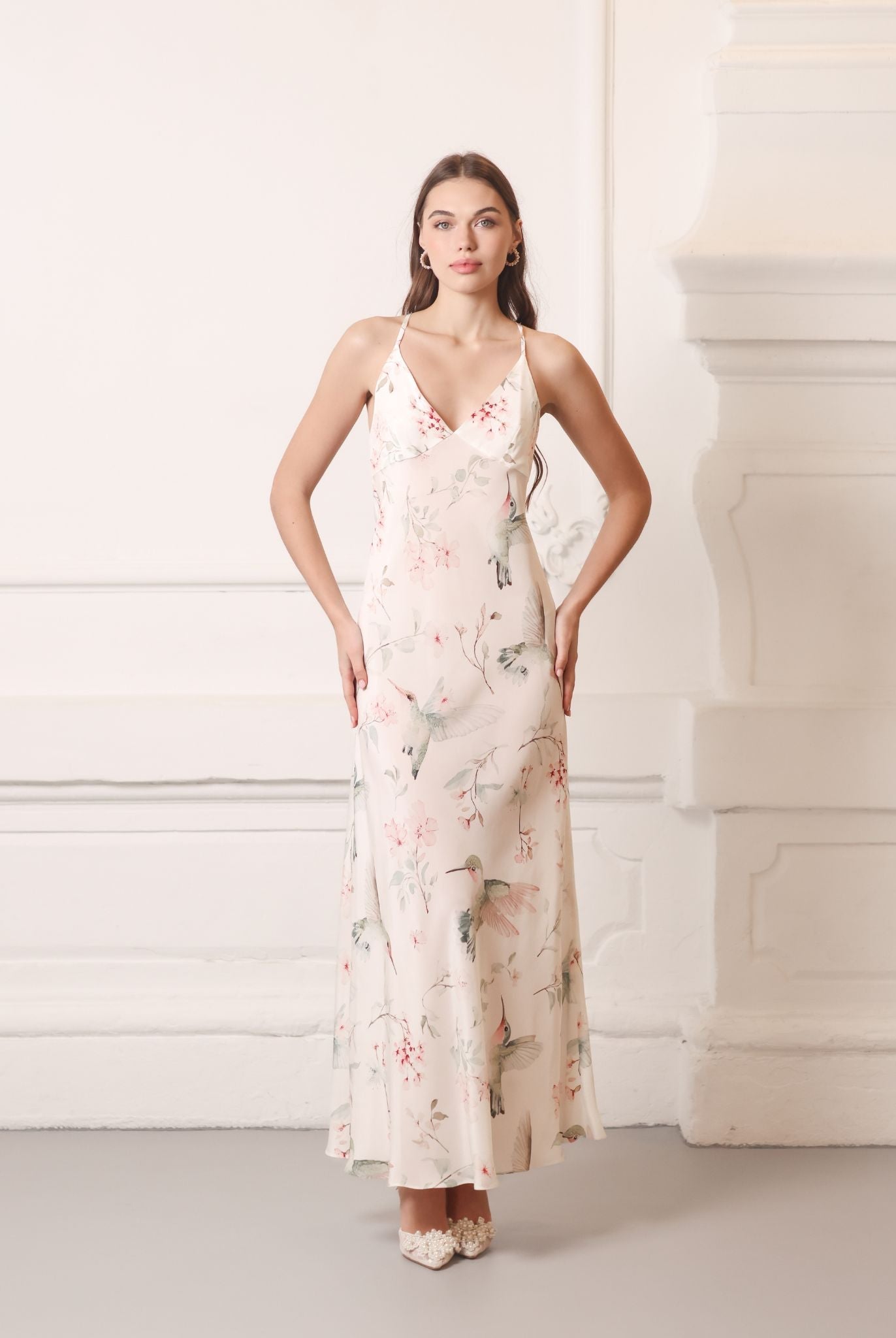Elegant silk crepe nightdress with hands on the waist, showcasing the artistic garden birds print and V-neckline.