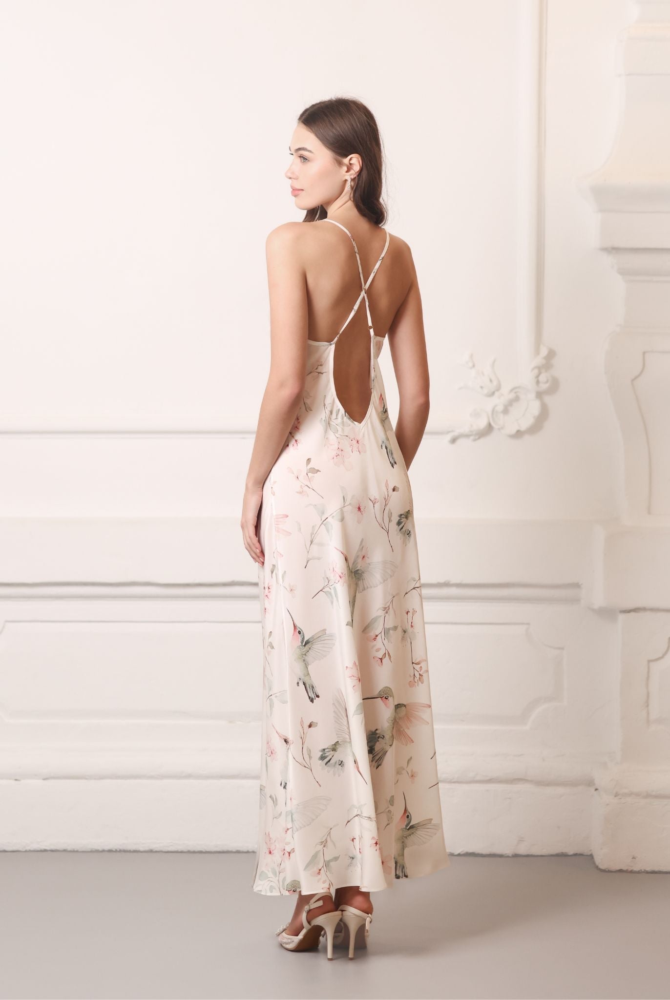 Back view of the silk nightgown highlighting crisscross straps and a mid-open V-cut for a sophisticated look.