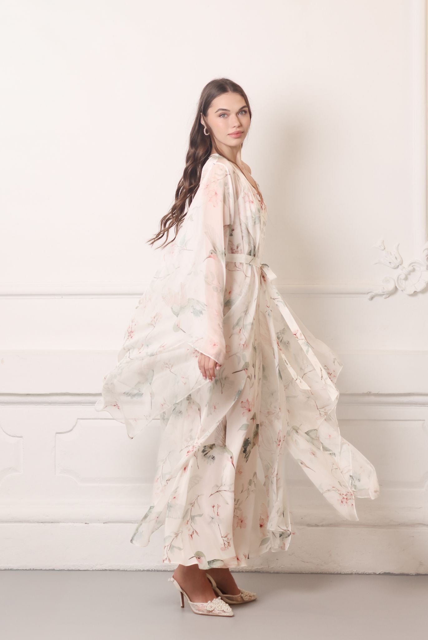 Dynamic shot of a sheer silk chiffon wrap rotating gracefully, highlighting the weightless and airy fabric.