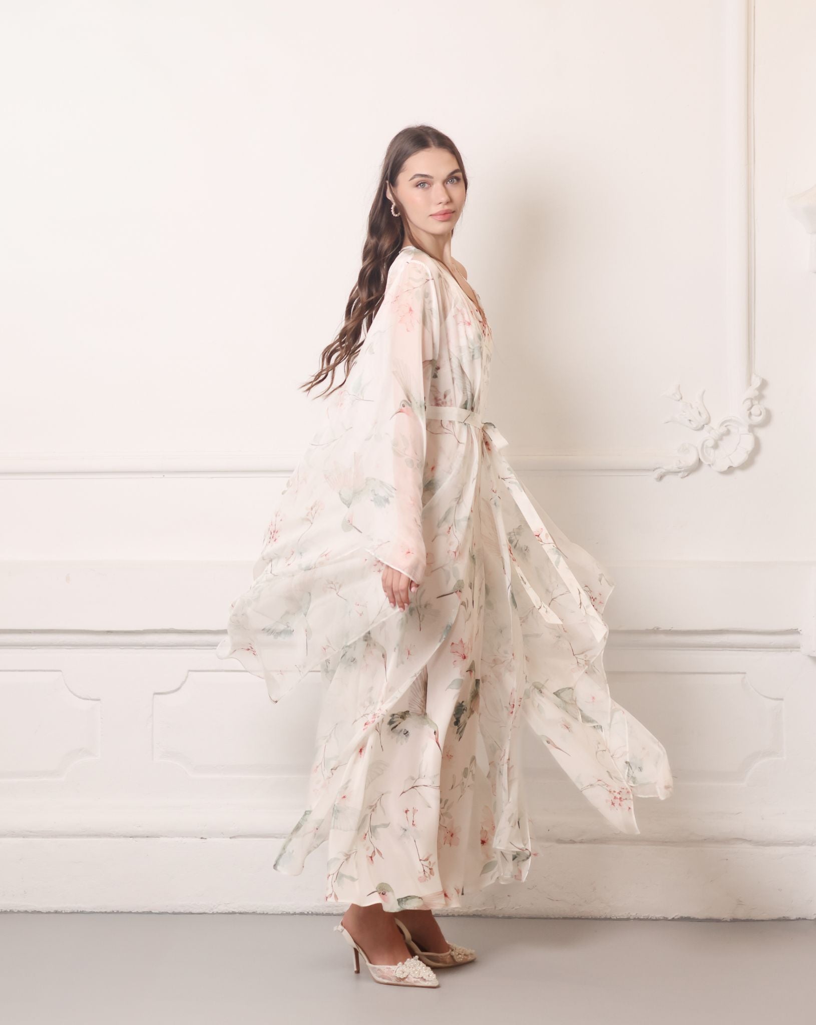 Dynamic shot of a sheer silk chiffon wrap rotating gracefully, highlighting the weightless and airy fabric.