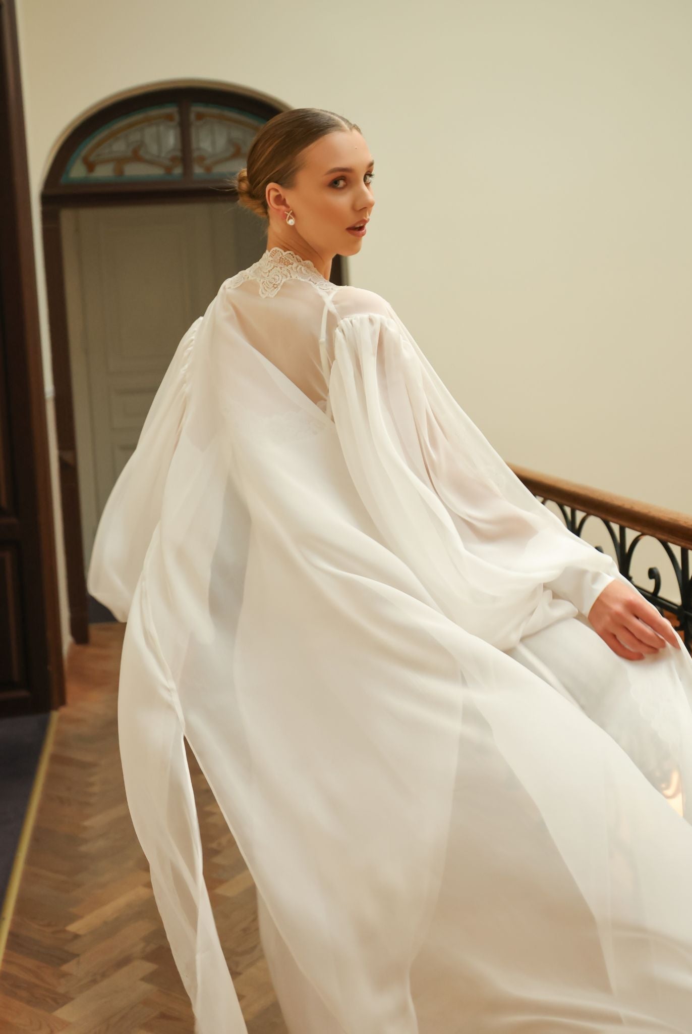 Rear perspective of the flowing silk wrap, showcasing the graceful drape and the refined style of the puffy sleeves.