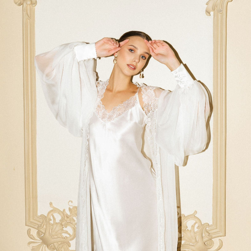Mid-length shot of the sheer silk wrap with puffy sleeves, featuring silk cuffs and delicate button detailing.