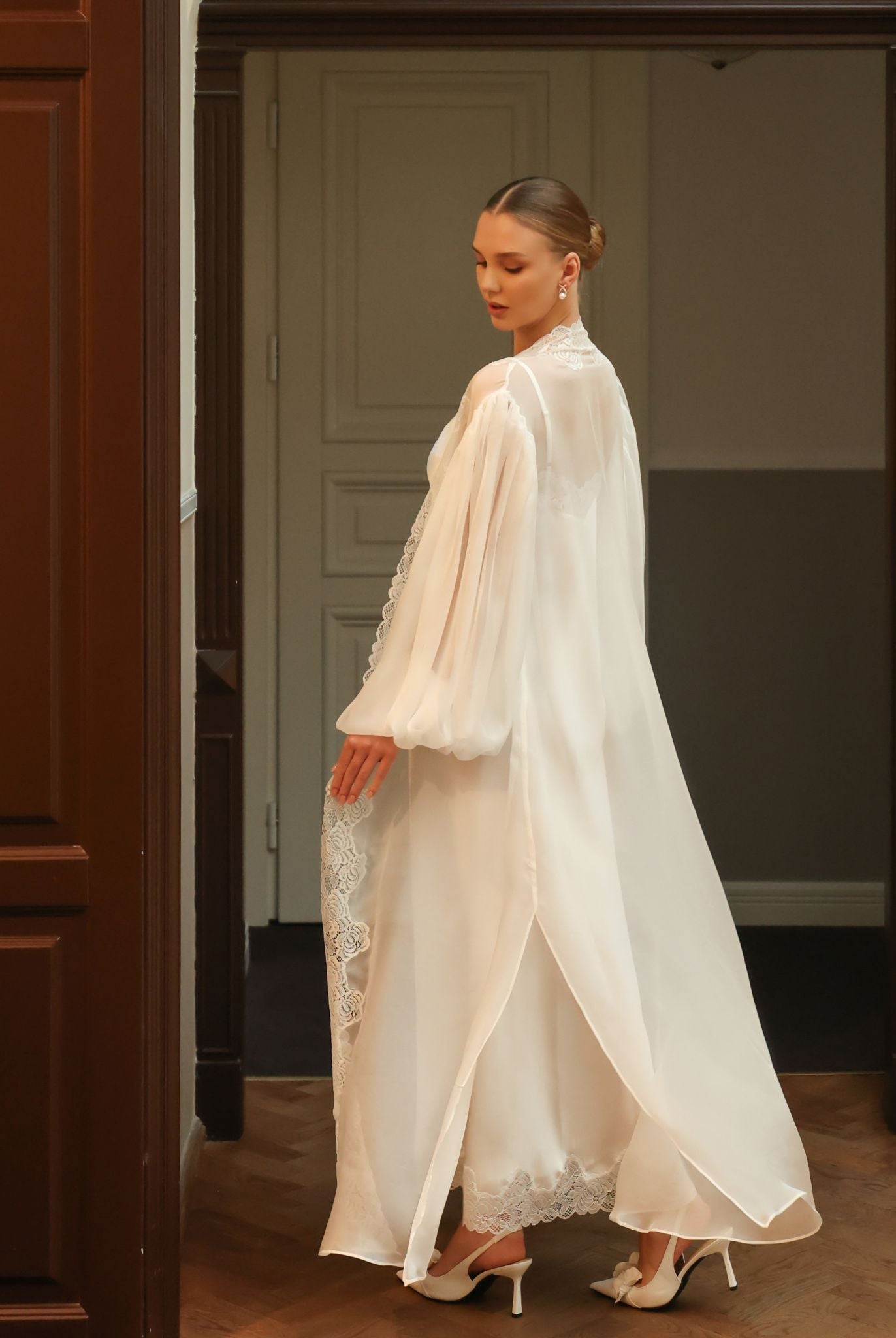 Full-length shot of the sheer robe in a playful twist, emphasizing the airy nature of the silk chiffon fabric.