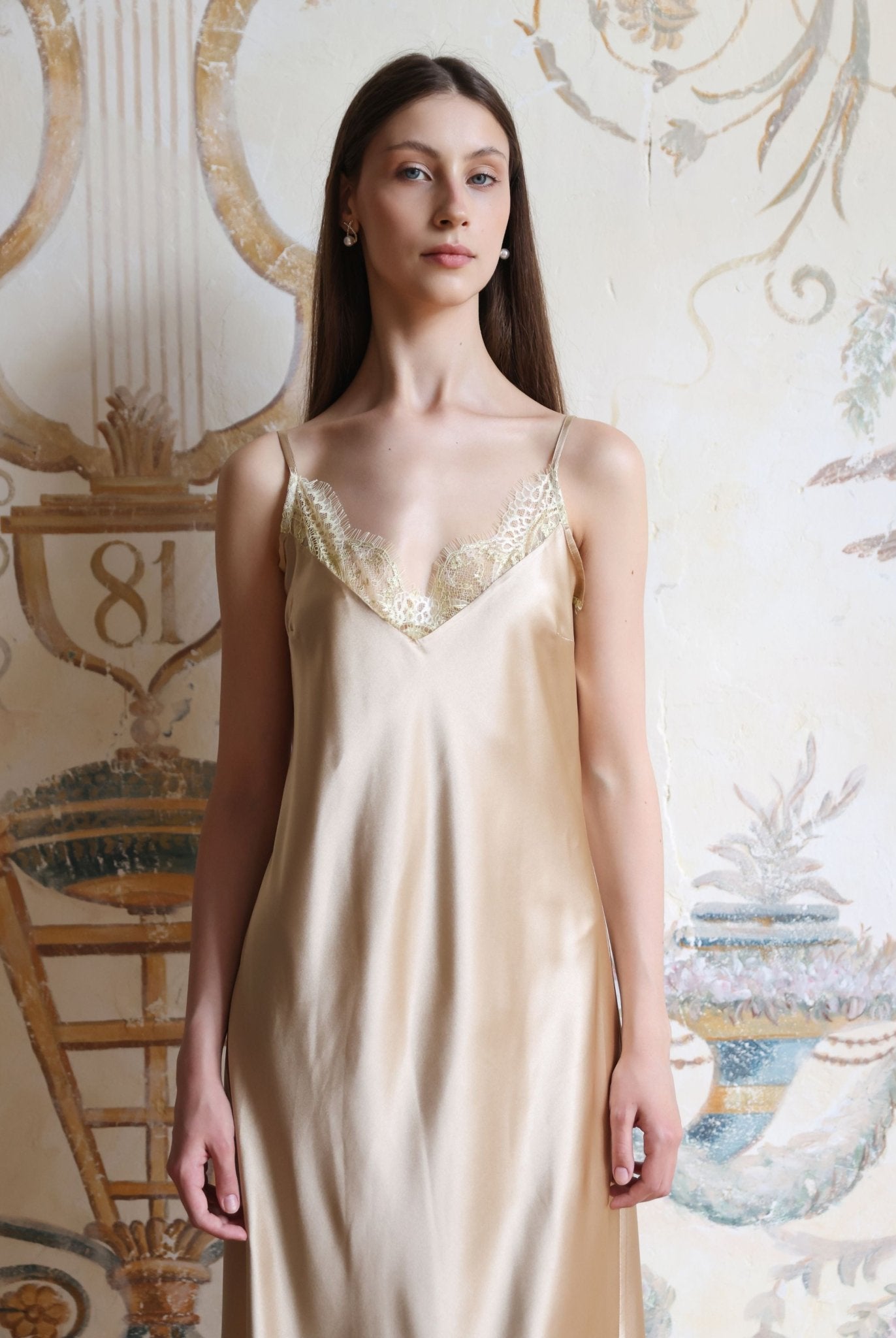 Mid-length frontal shot of the satin nightdress, showcasing the flowing lace-trimmed hem and smooth finish.