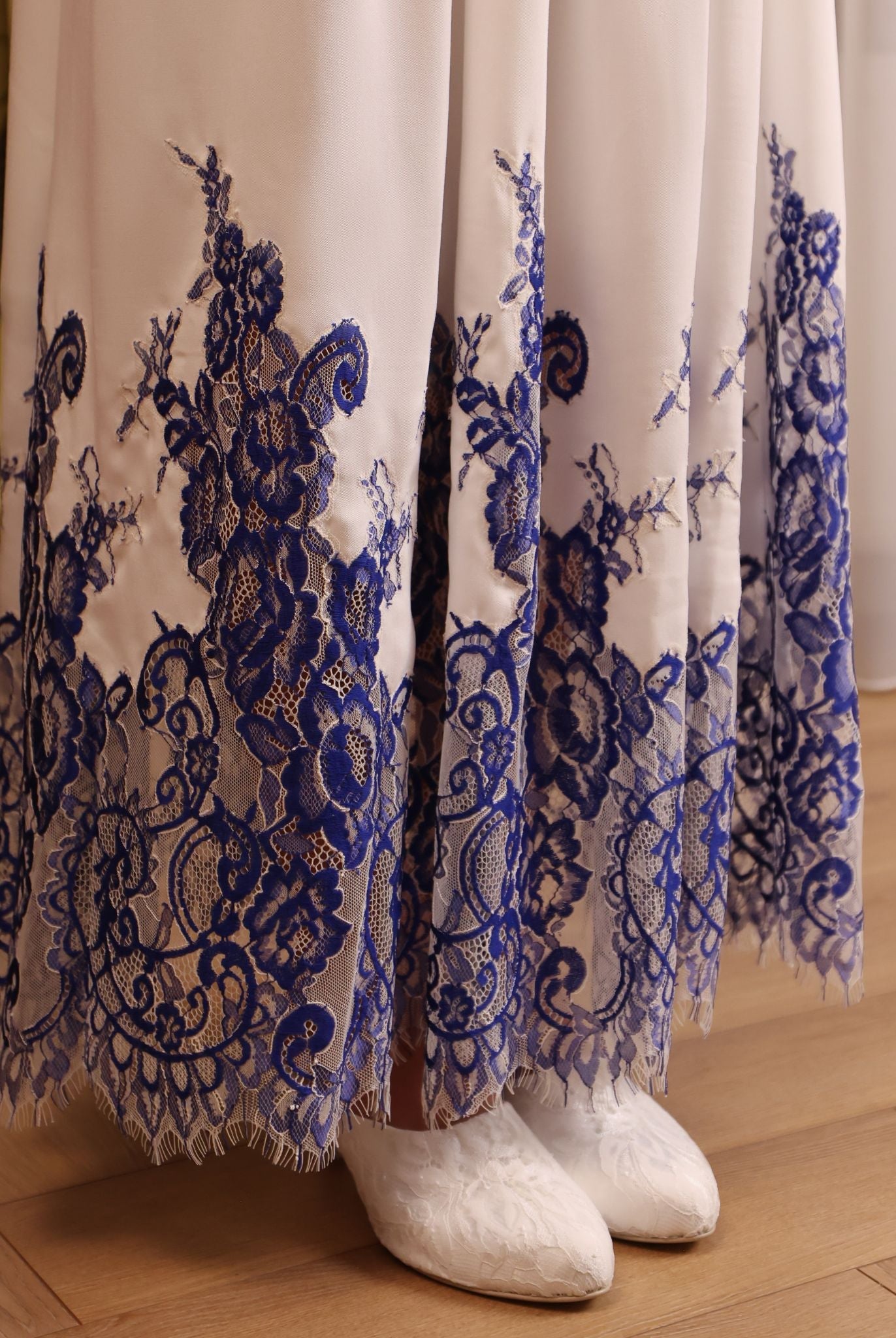 Close-up of the nightgown’s hem, showcasing the delicate French lace trim that adds a refined touch to the design.
