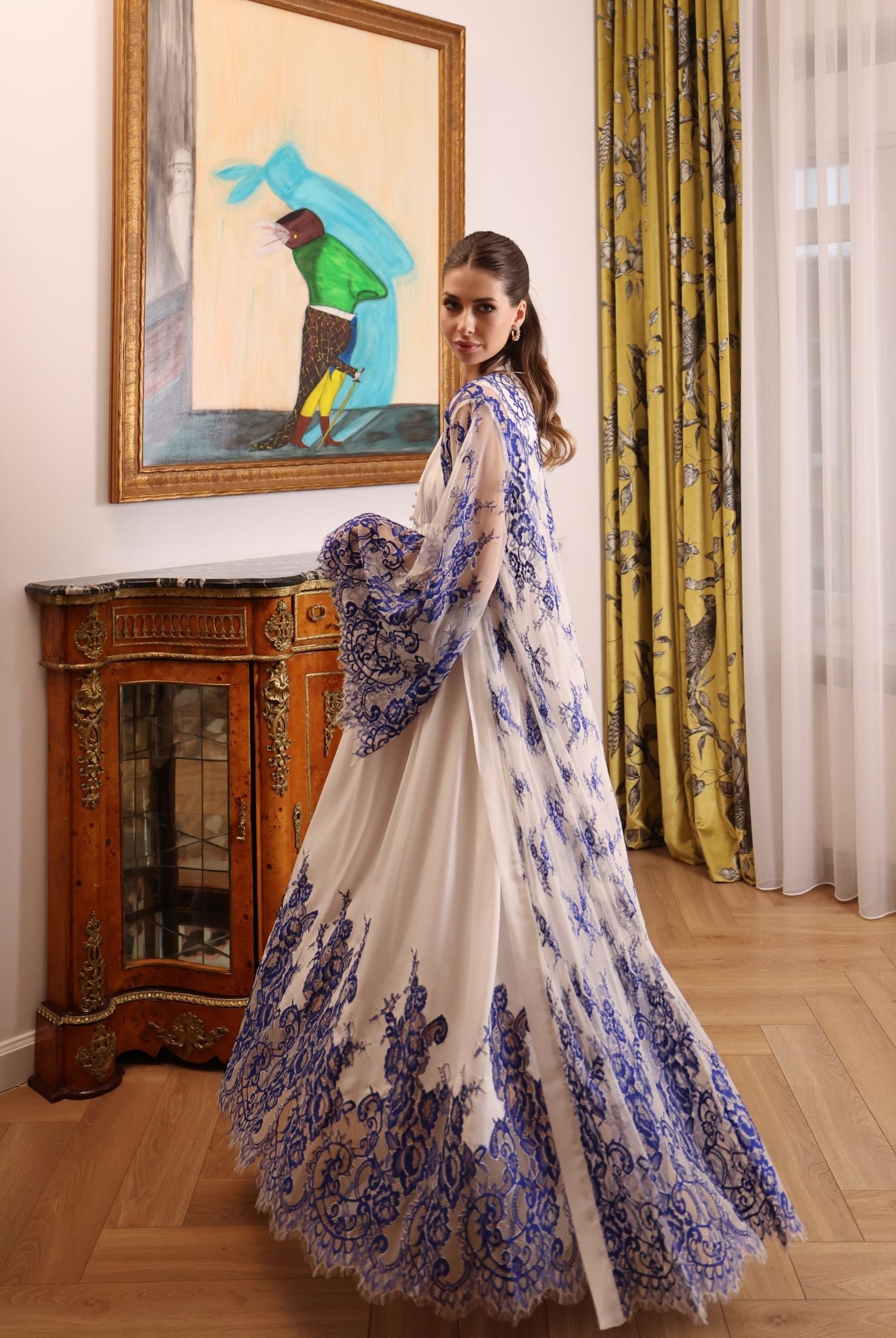 A dynamic shot of the ensemble during a turn, illustrating the elegant patterns of the sheer lace robe.