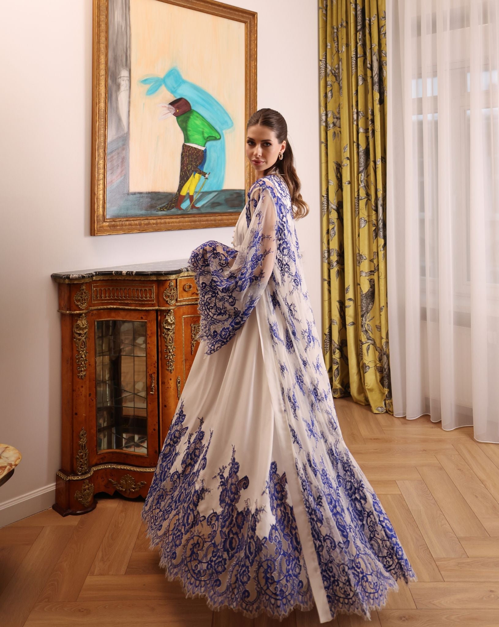 A dynamic shot of the ensemble during a turn, illustrating the elegant patterns of the sheer lace robe.