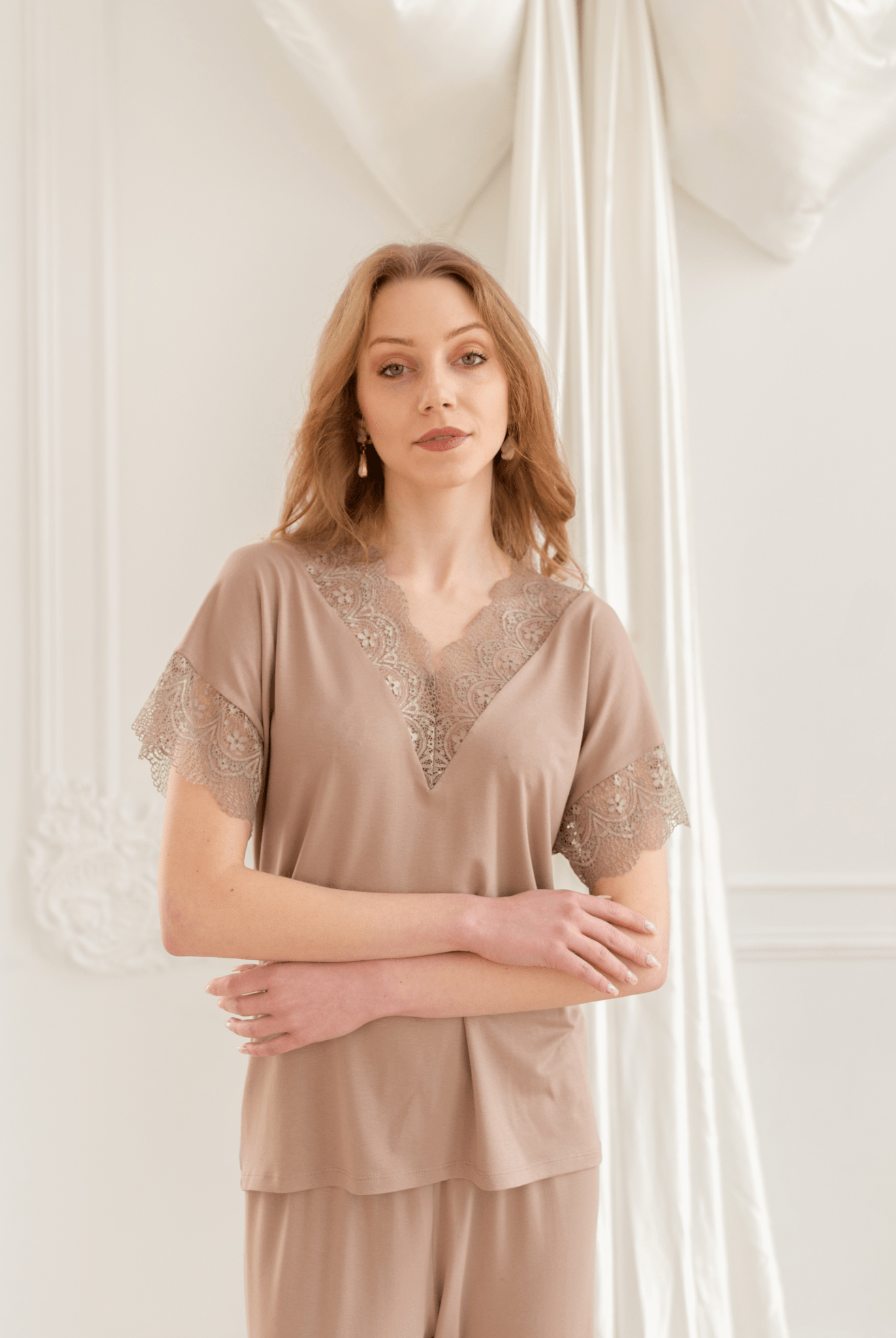 Mid-length shot with hands on the waist, showcasing the thin, breathable texture and lace-embellished shirt top.