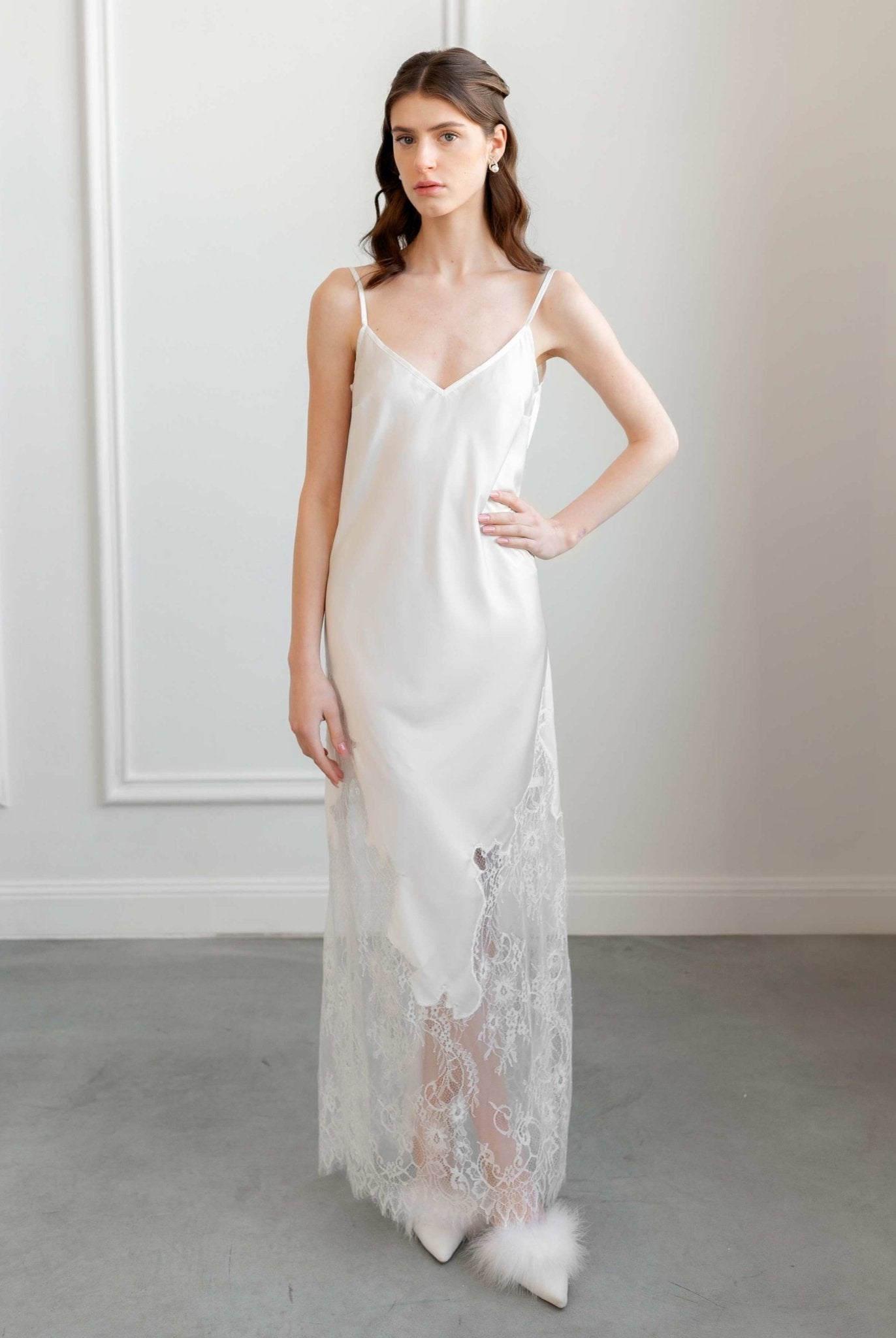Front view of ivory satin slip dress with sheer lace hem, bridal elegance