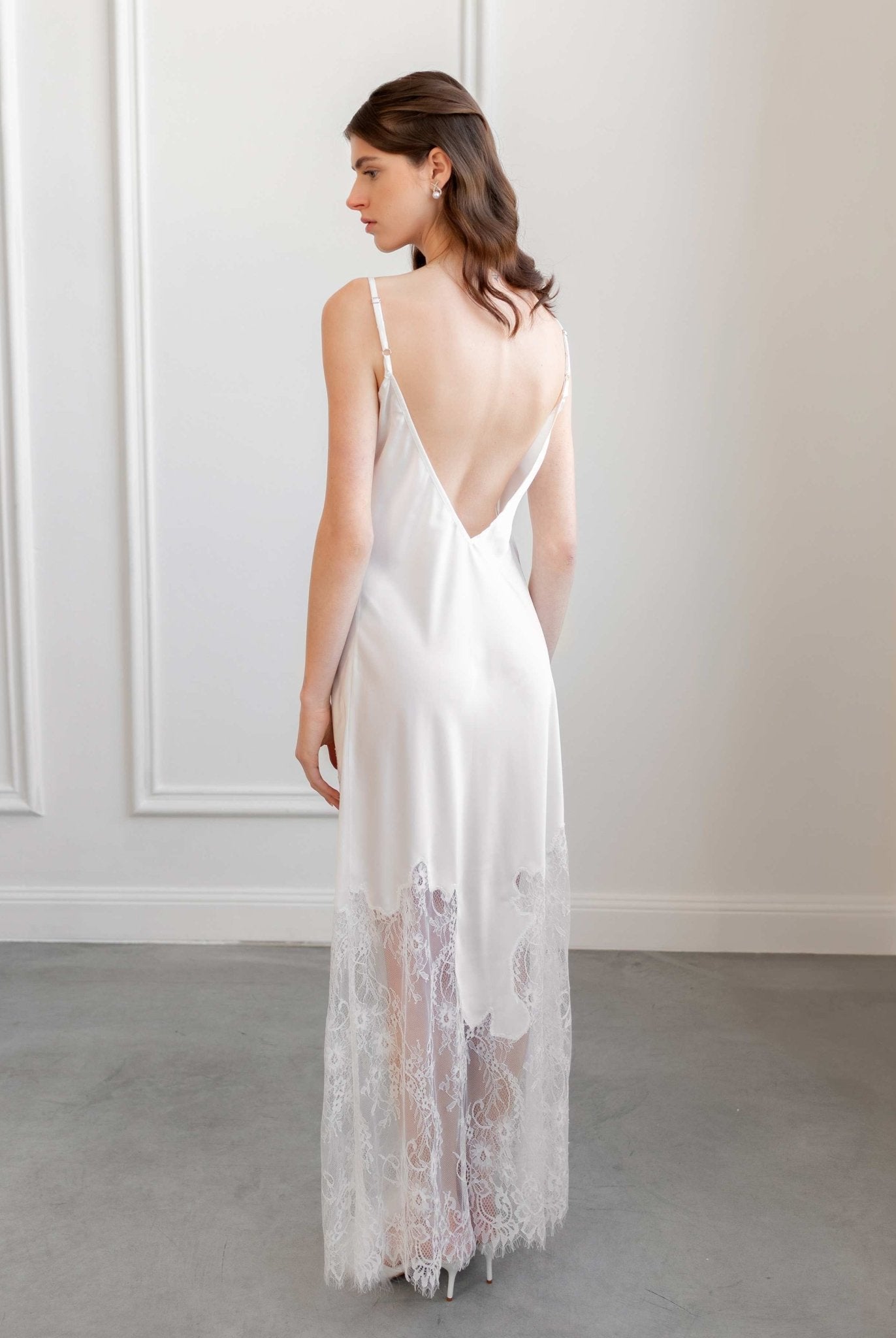 Back view of satin nightgown with lace train, photographed in daylight studio