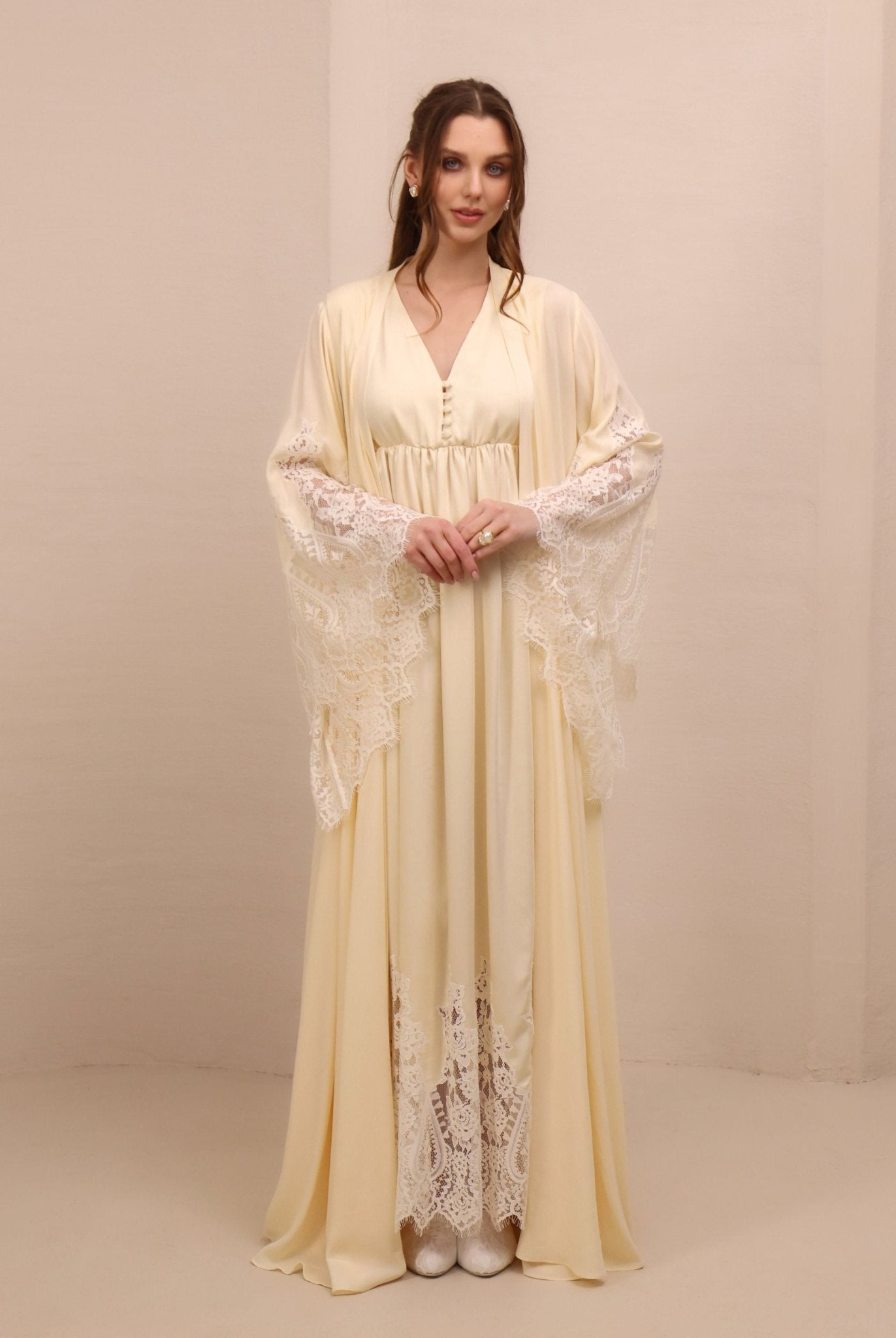 A frontal shot highlighting the wide lace-trimmed sleeves for added elegance and a timeless, graceful silhouette.