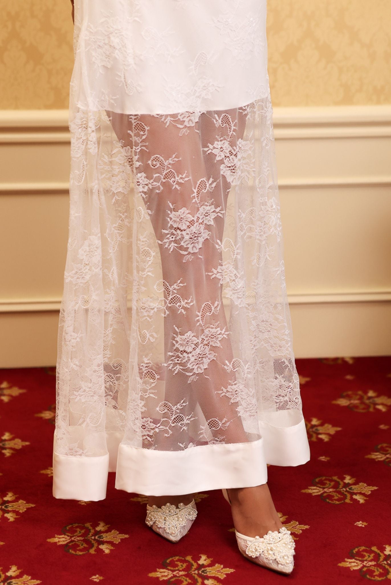 Close-up of the bottom hem, featuring beautiful floral lace that adds a romantic finish to the flowing silhouette.
