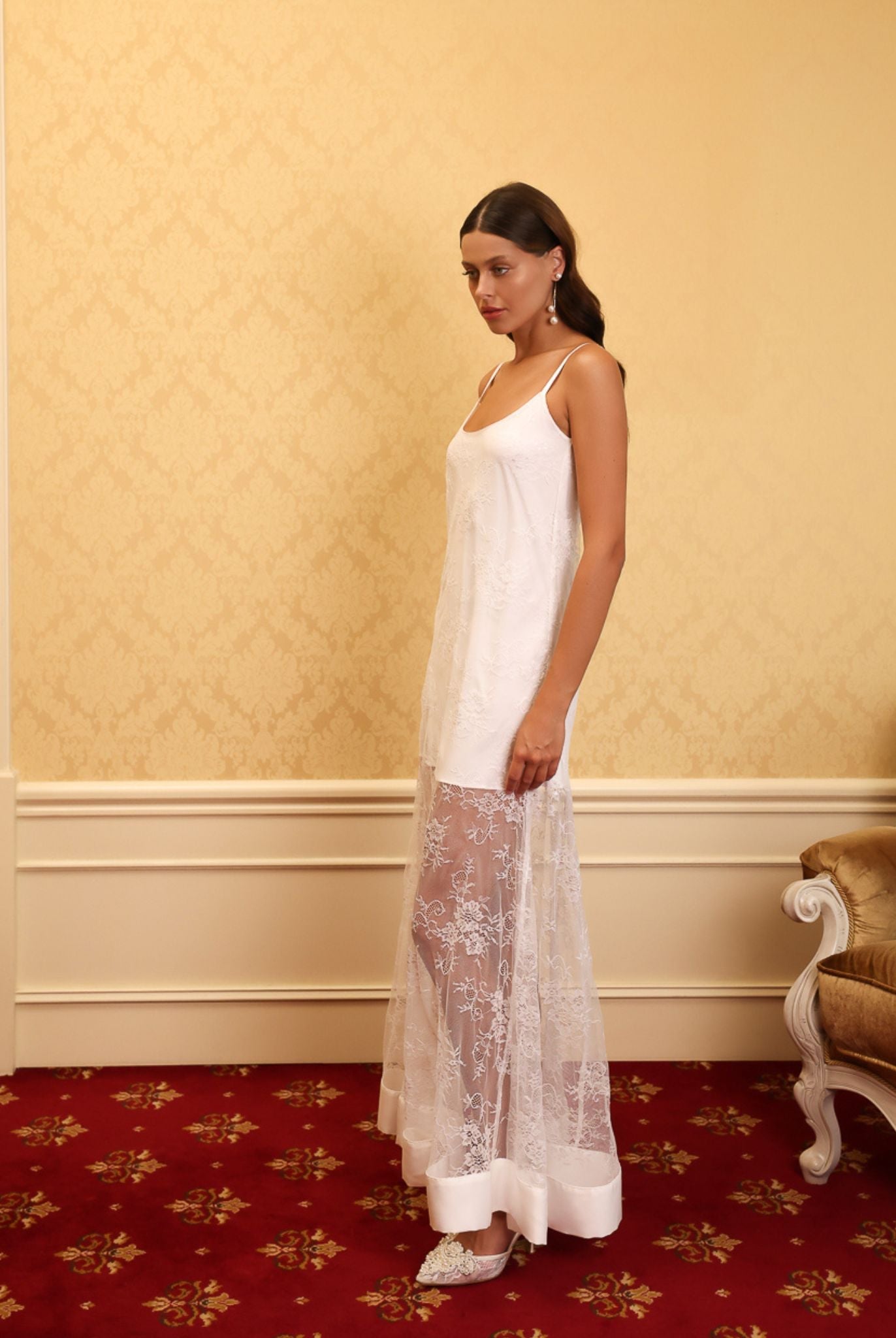 Side view of the long white nightdress, highlighting the effortless grace and the beautiful play of light on satin.