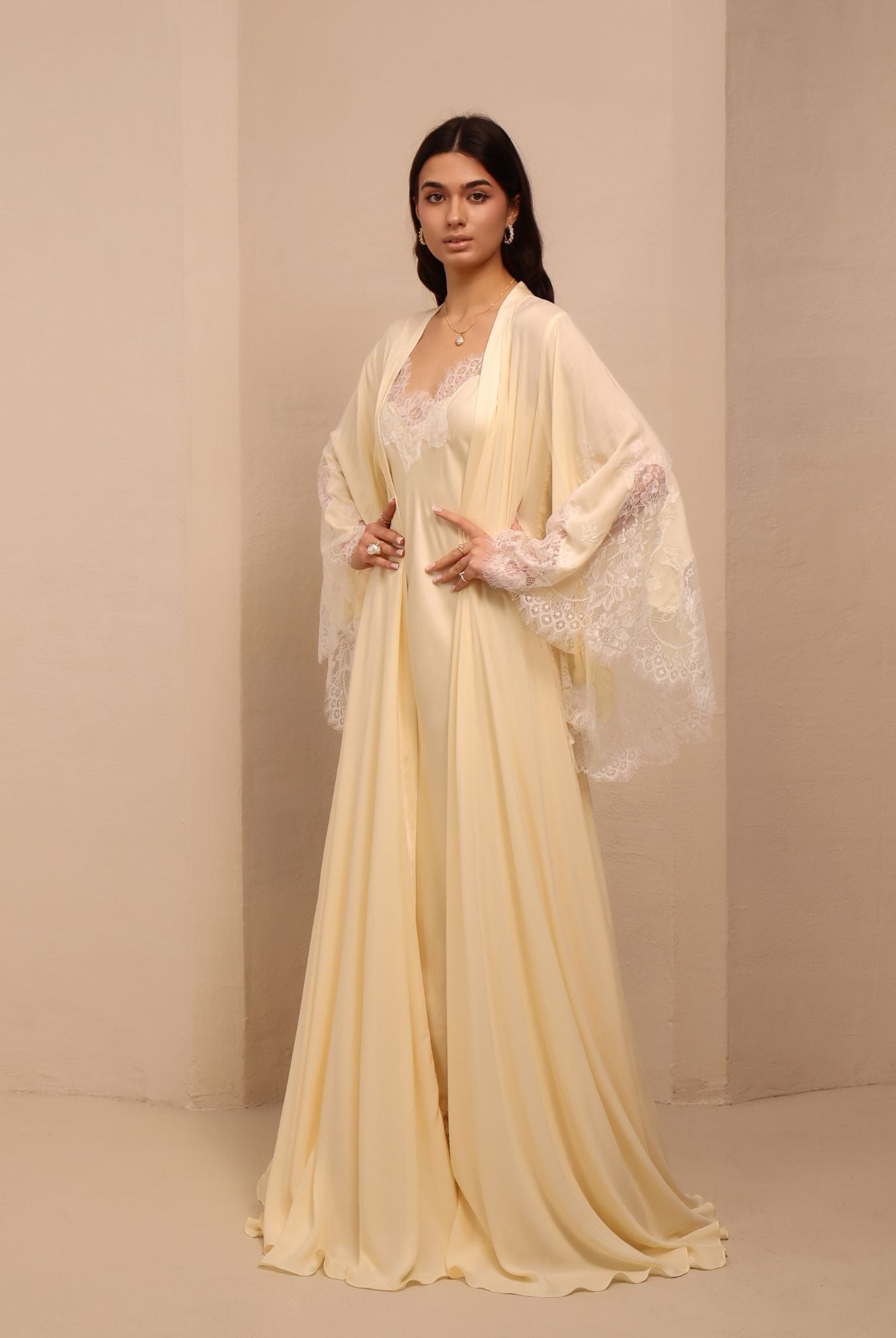 Side perspective of the attire, featuring small lace flowers sewn onto the fabric for a delicate touch.