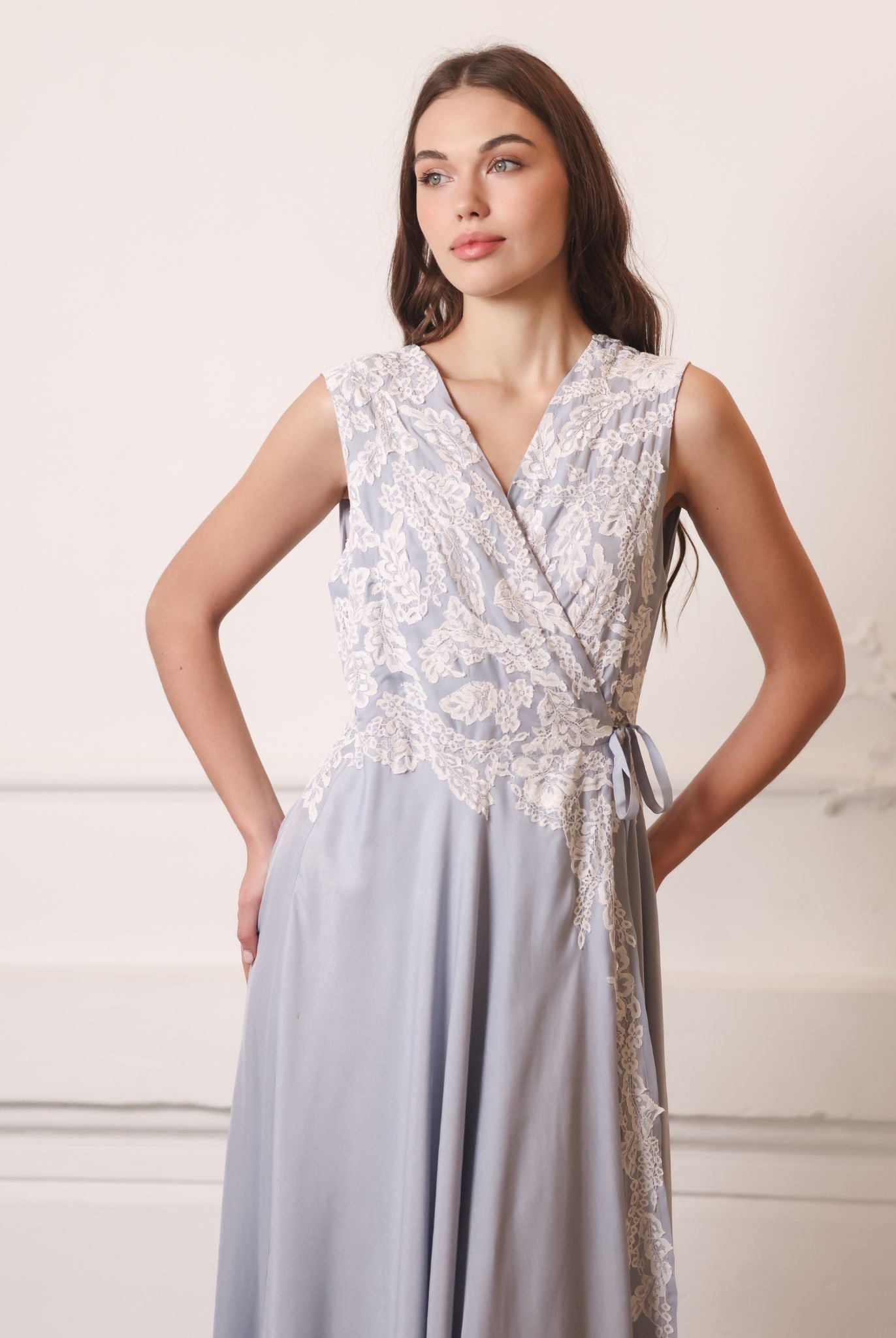 A focused shot of the nightgown with hands on hips, drawing attention to the intricate lace embellishments.