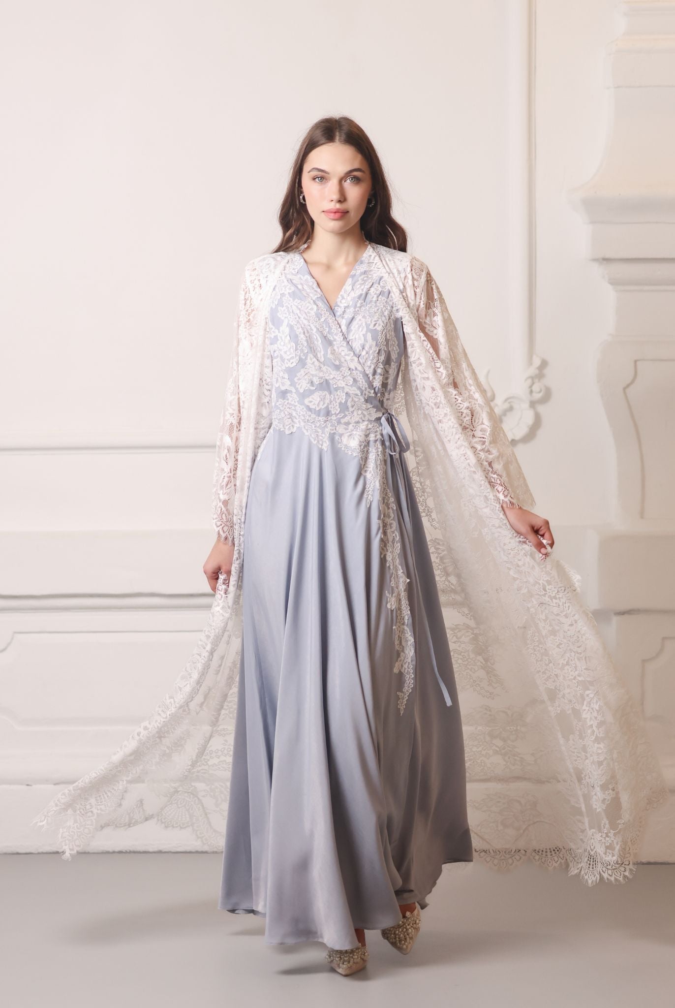 A dynamic walking shot with the sheer lace robe billowing softly behind, creating a romantic trailing effect.